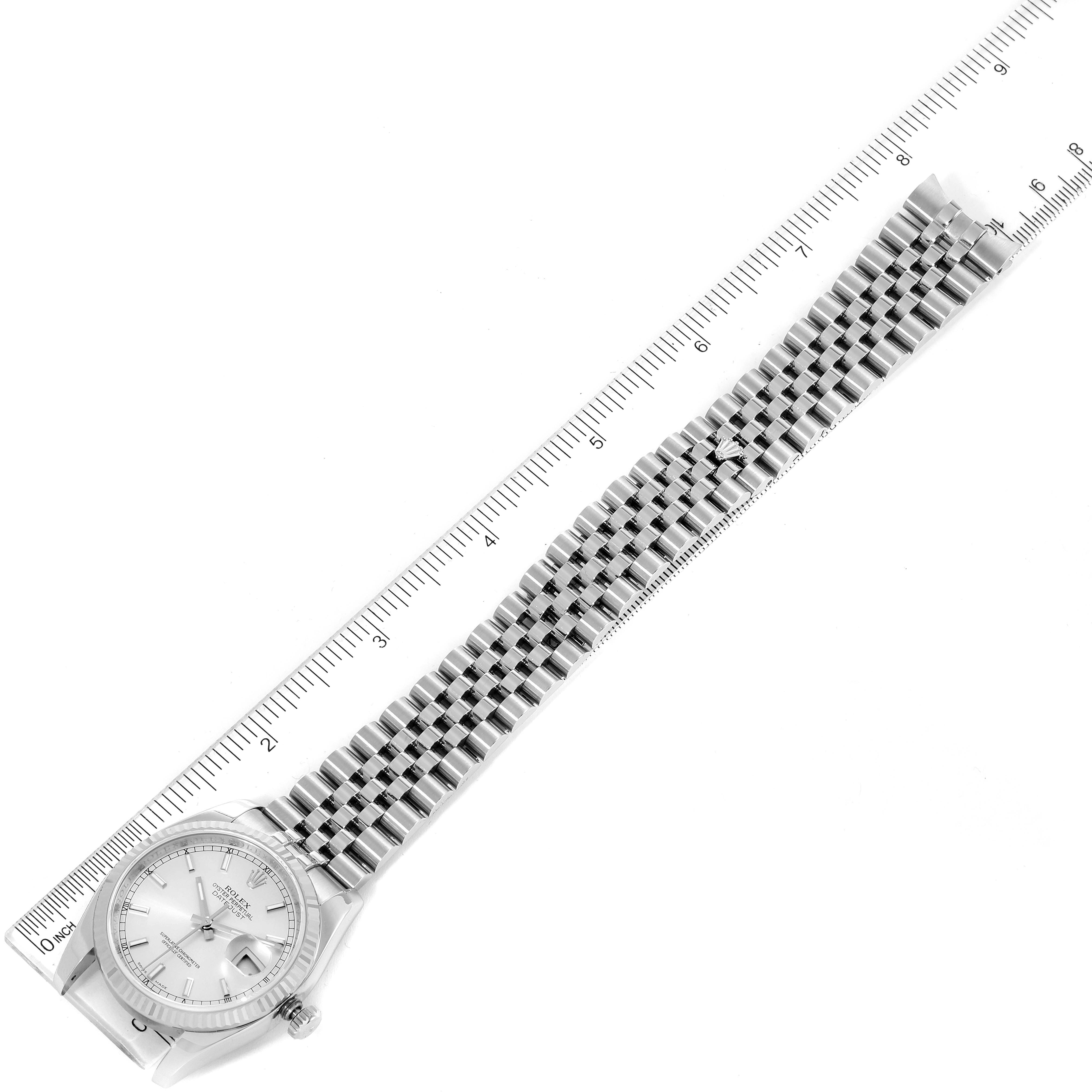The image shows a top-down view of a Rolex Datejust 116234 Men's Stainless Steel Silver Dial 116234 Men's Stainless Steel Silver Dial watch with a full bracelet and a ruler for scale.