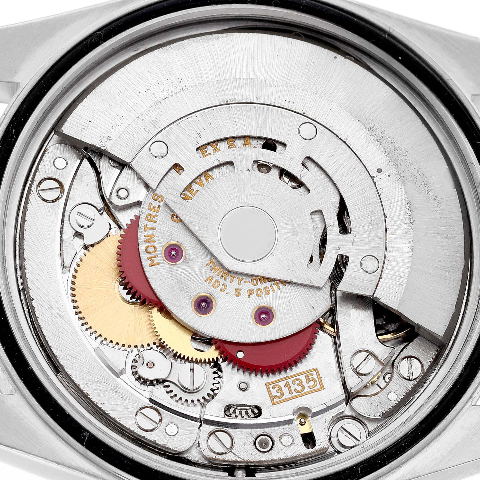 The image shows the movement of a Rolex Datejust 16234 Men's Stainless Steel Silver Dial watch viewed from the back, highlighting gears and the rotor.
