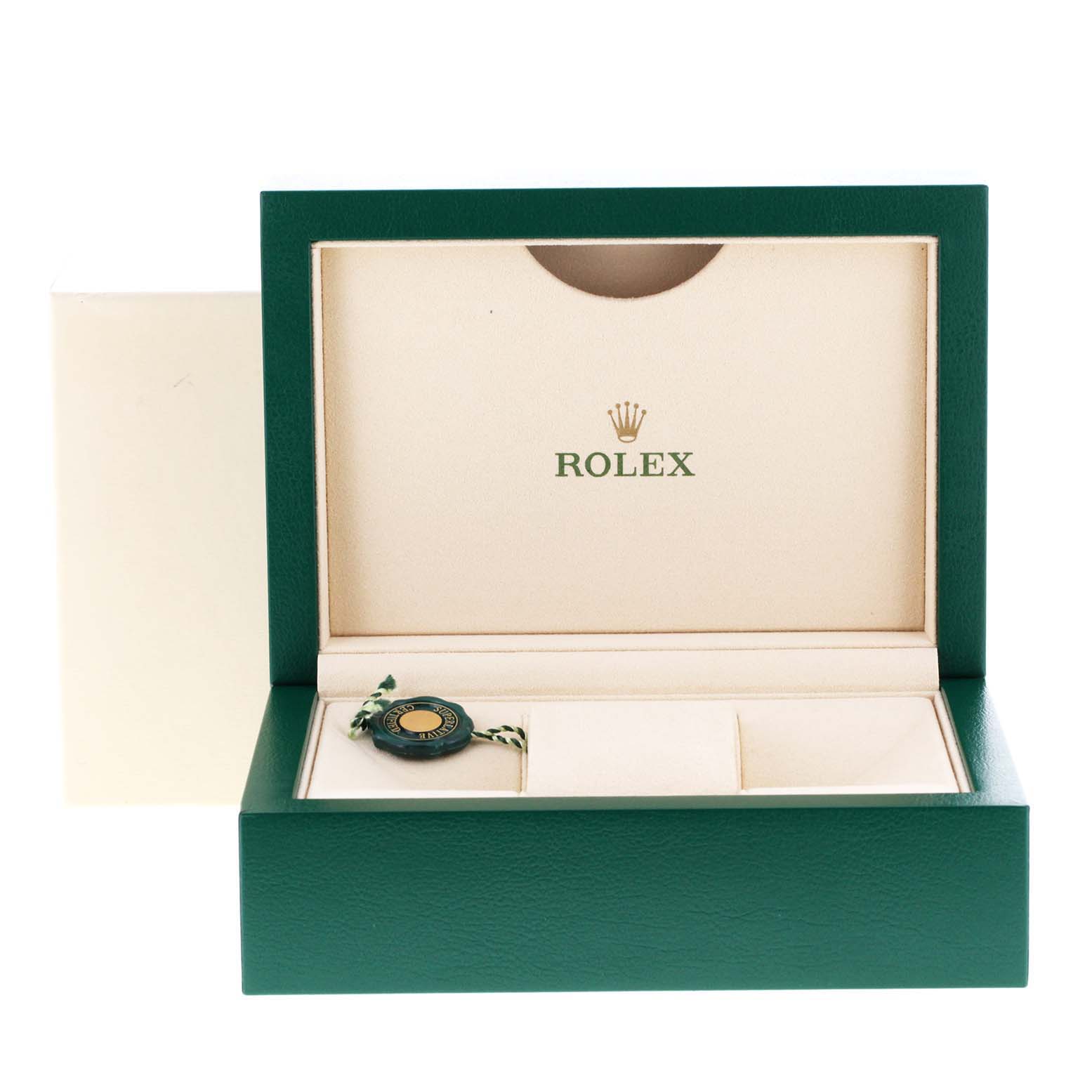 This image shows an open green and beige Rolex box, likely for a Datejust model watch, displaying the logo and a tag inside.