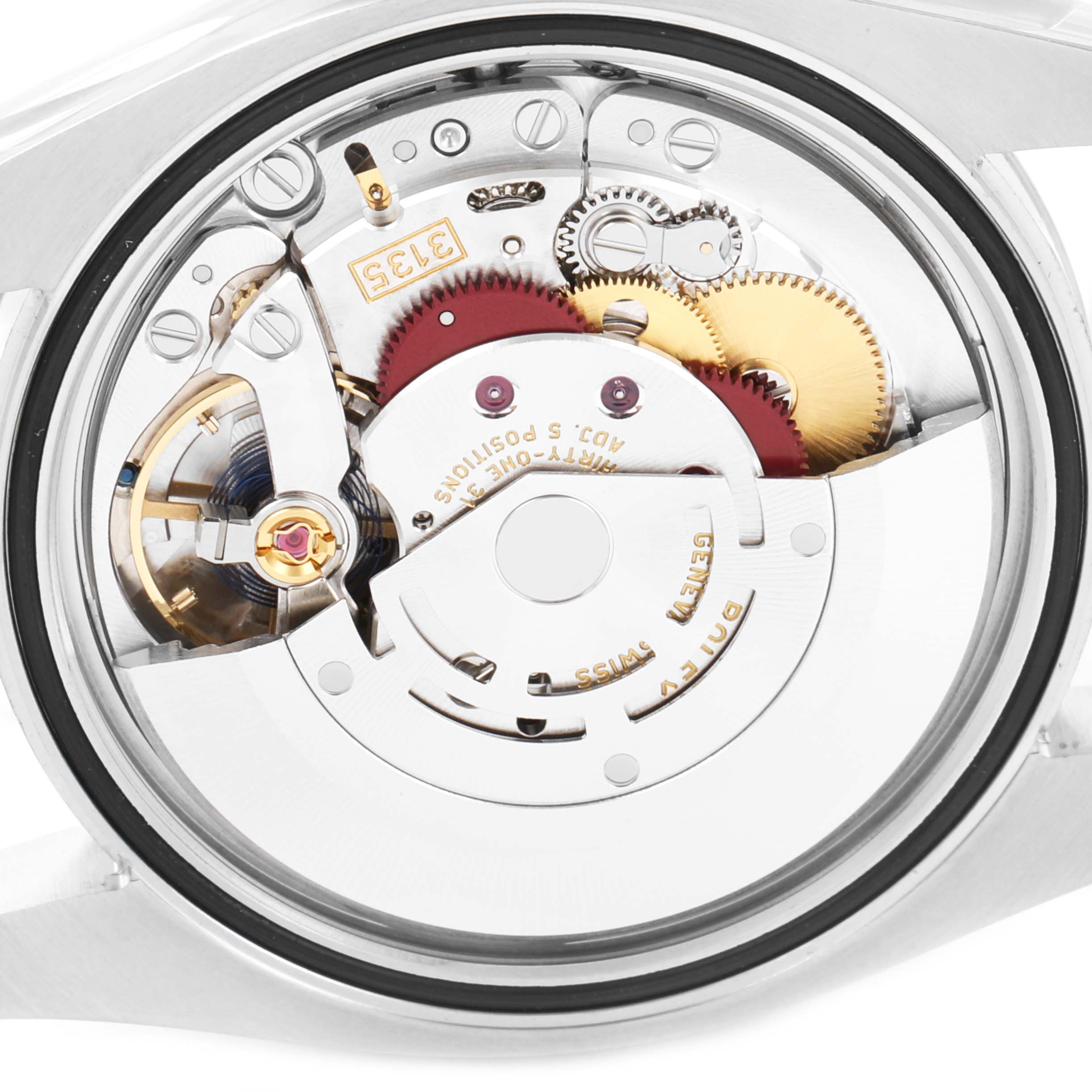 The image shows the inner mechanical movement of a Rolex Datejust 116234 Men
s Stainless Steel White Dial 116234 Men
s Stainless Steel White Dial watch, including gears, balance wheel, and rotor.