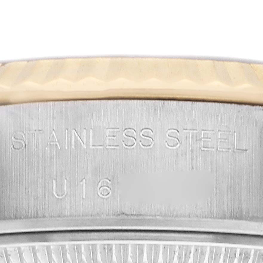 The image shows a close-up of the side of a Rolex Datejust 69173 Women
s Steel and Gold (two tone) Champagne Dial 69173 Women
s Steel and Gold (two tone) Champagne Dial
s bezel and case, with "STAINLESS STEEL" engraved.