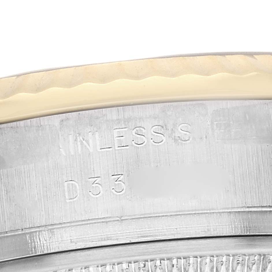 The image shows a close-up of the edge and engraved parts of a Rolex Datejust 179173 Women
s Steel and Gold (two tone) Black Dial 179173 Women
s Steel and Gold (two tone) Black Dial watch case.