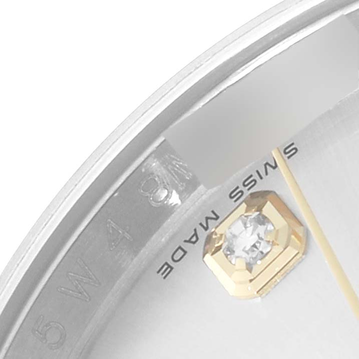 Close-up of a Rolex Datejust 116233 Men's Steel and Gold (two tone) Silver Dial 116233 Men's Steel and Gold (two tone) Silver Dial watch dial showing the "Swiss Made" text and part of a diamond hour marker.