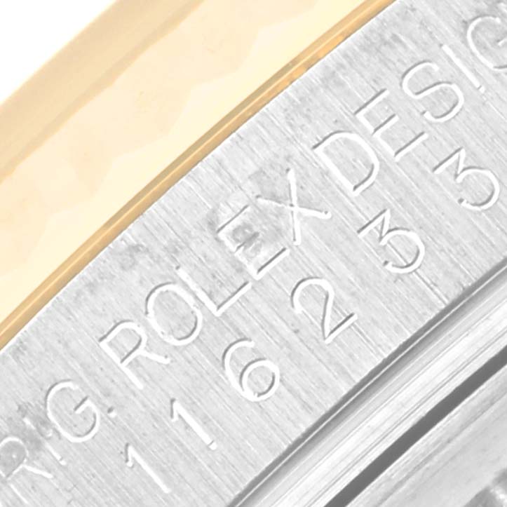 A close-up view of the Rolex Datejust 116233 Men's Steel and Gold (two tone) Silver Dial 116233 Men's Steel and Gold (two tone) Silver Dial model, specifically the engraved edge of the watch case.