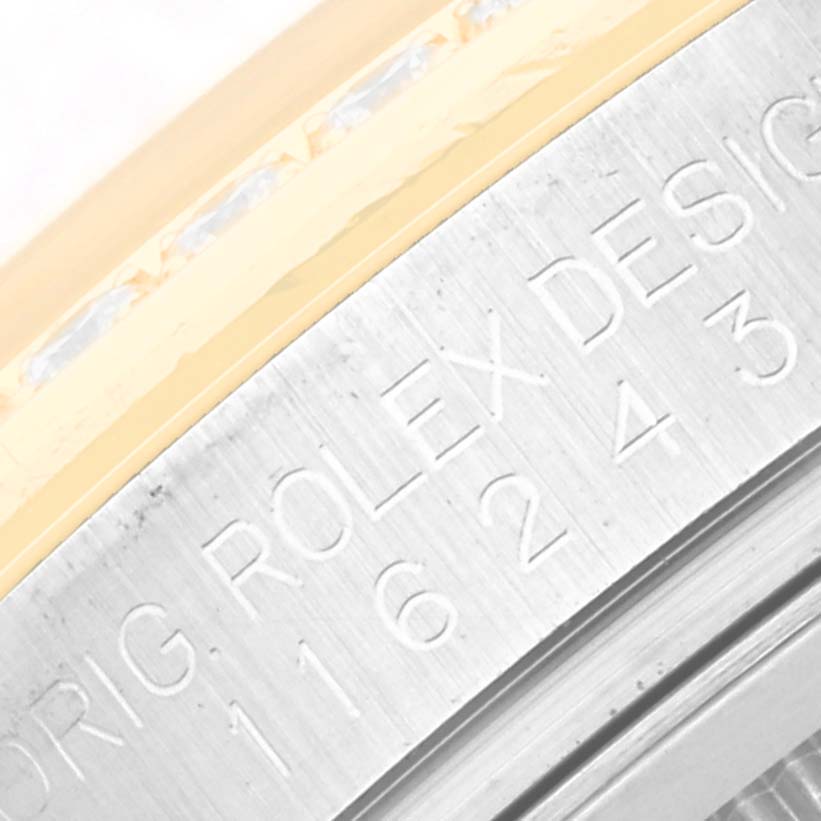 The image shows a close-up of the Rolex Datejust 116243 Men's Steel and Gold (two tone) White Dial 116243 Men's Steel and Gold (two tone) White Dial's engraved model number on its side, near the bezel.