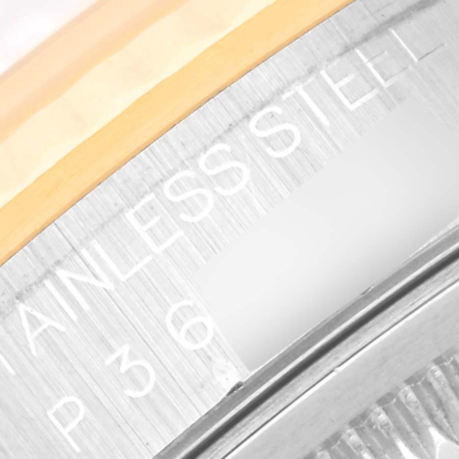 Close-up image showing the side of the Rolex Datejust 16233 Men's Steel and Gold (two tone) Blue Dial 16233 Men's Steel and Gold (two tone) Blue Dial watch, specifically the metal edge with engraved text.