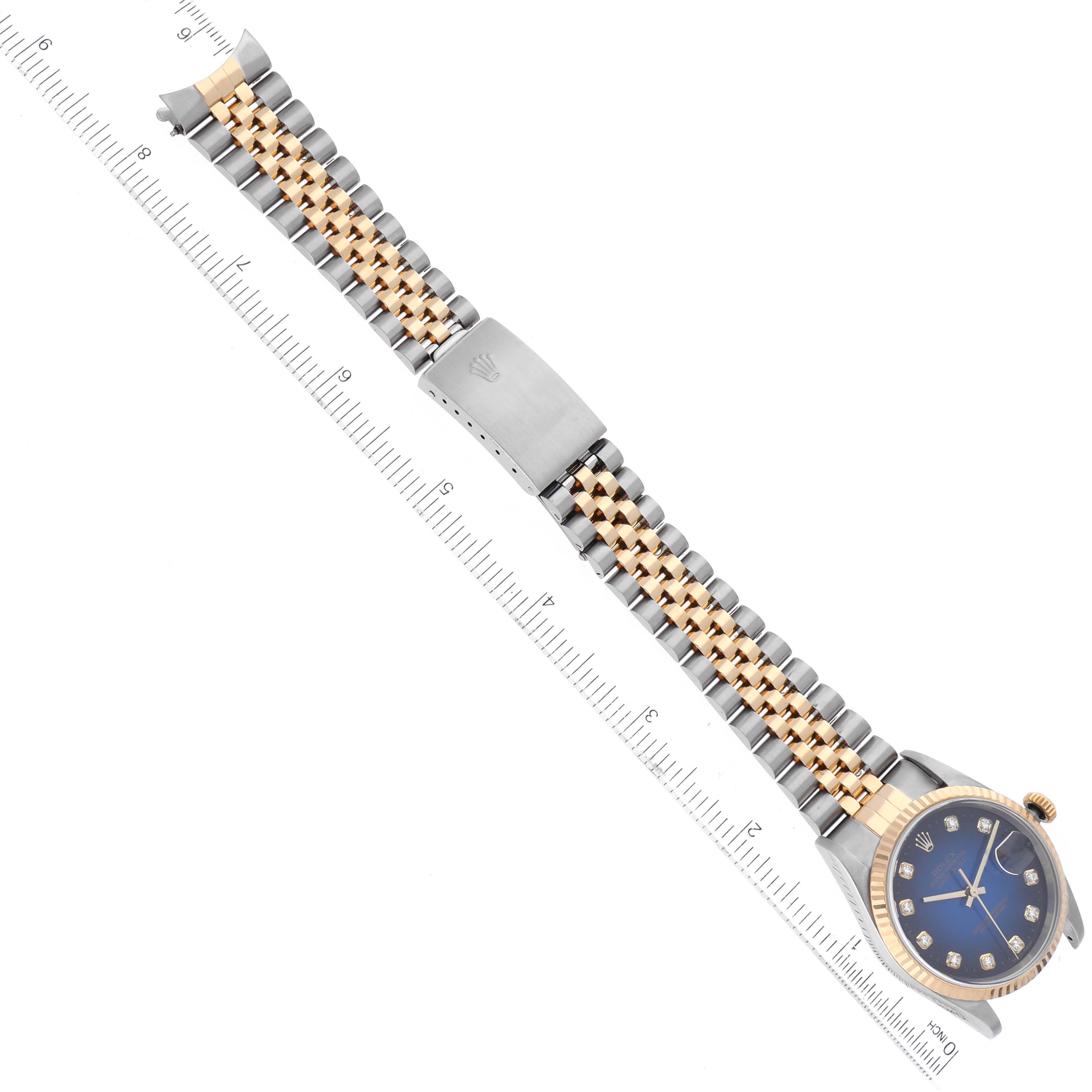 The image shows a Rolex Datejust 16233 Men's Steel and Gold (two tone) Blue Dial 16233 Men's Steel and Gold (two tone) Blue Dial watch laid flat, displaying its bracelet and face, measured against a ruler.