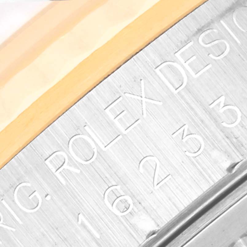 The image shows a close-up view of the side engraving on the case of a Rolex Datejust 16233 Men's Steel and Gold (two tone) Blue Dial 16233 Men's Steel and Gold (two tone) Blue Dial watch.