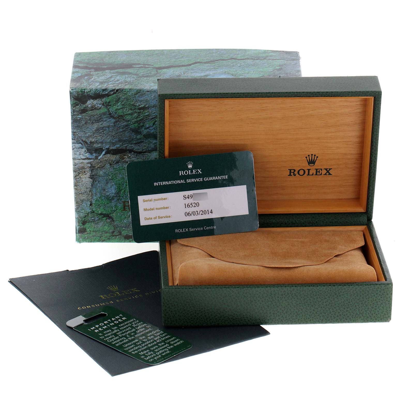 The image shows a Rolex Daytona 16520 Men's Stainless Steel Black Dial 16520 Men's Stainless Steel Black Dial model watch box, international service guarantee card, and accompanying documents.