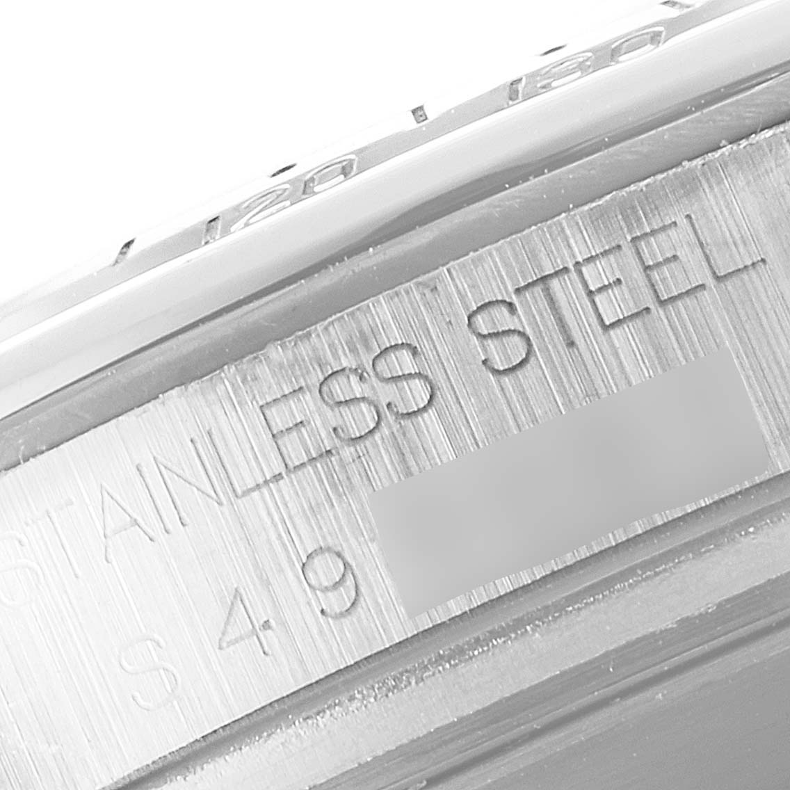 The image shows a close-up of the side of the Rolex Daytona 16520 Men's Stainless Steel Black Dial 16520 Men's Stainless Steel Black Dial watch, focusing on the stainless steel material marking.