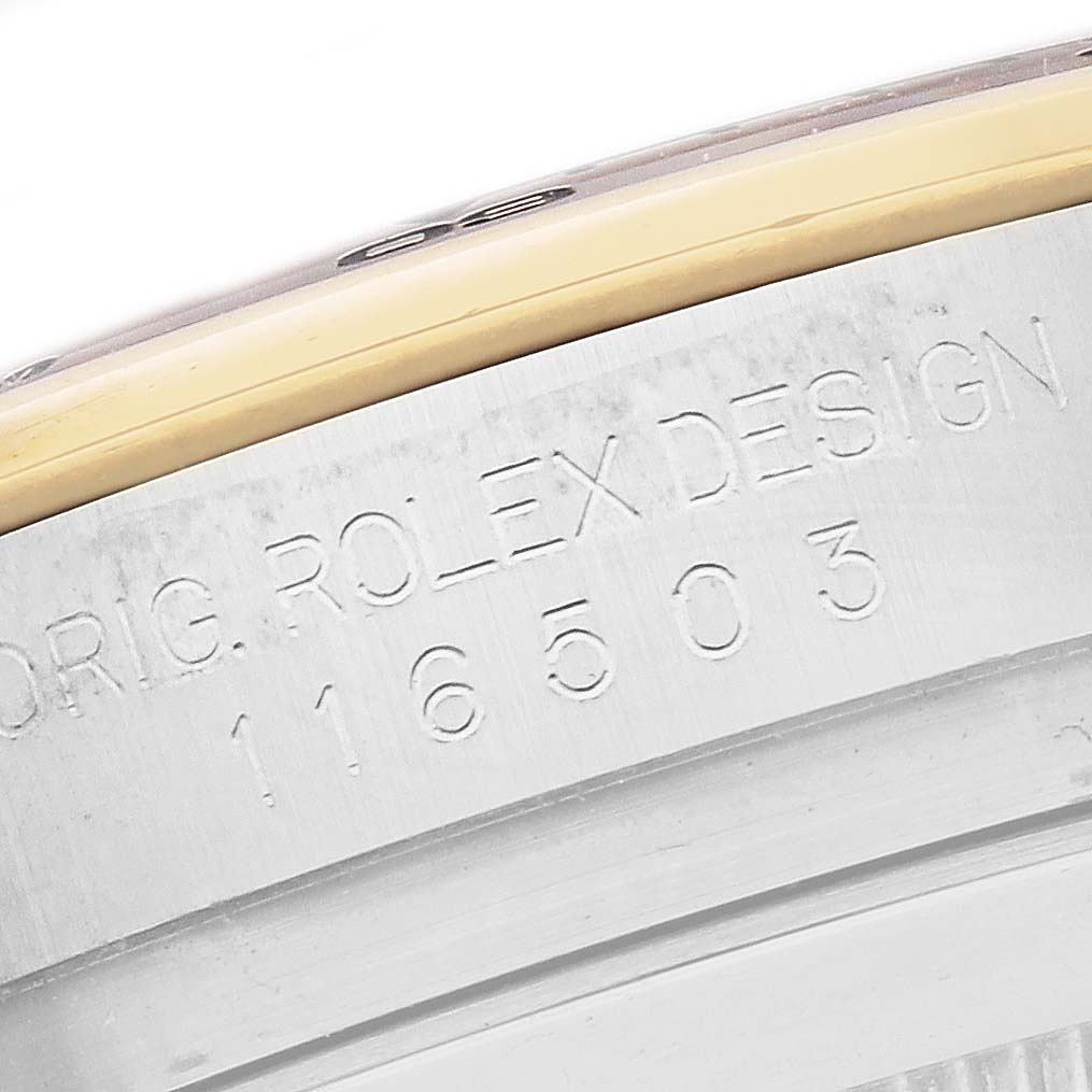 The image shows a close-up of the serial and model engraving on the side of a Rolex Daytona 116503 Men
s Steel and Gold (two tone) Blue Dial 116503 Men
s Steel and Gold (two tone) Blue Dial watch case.