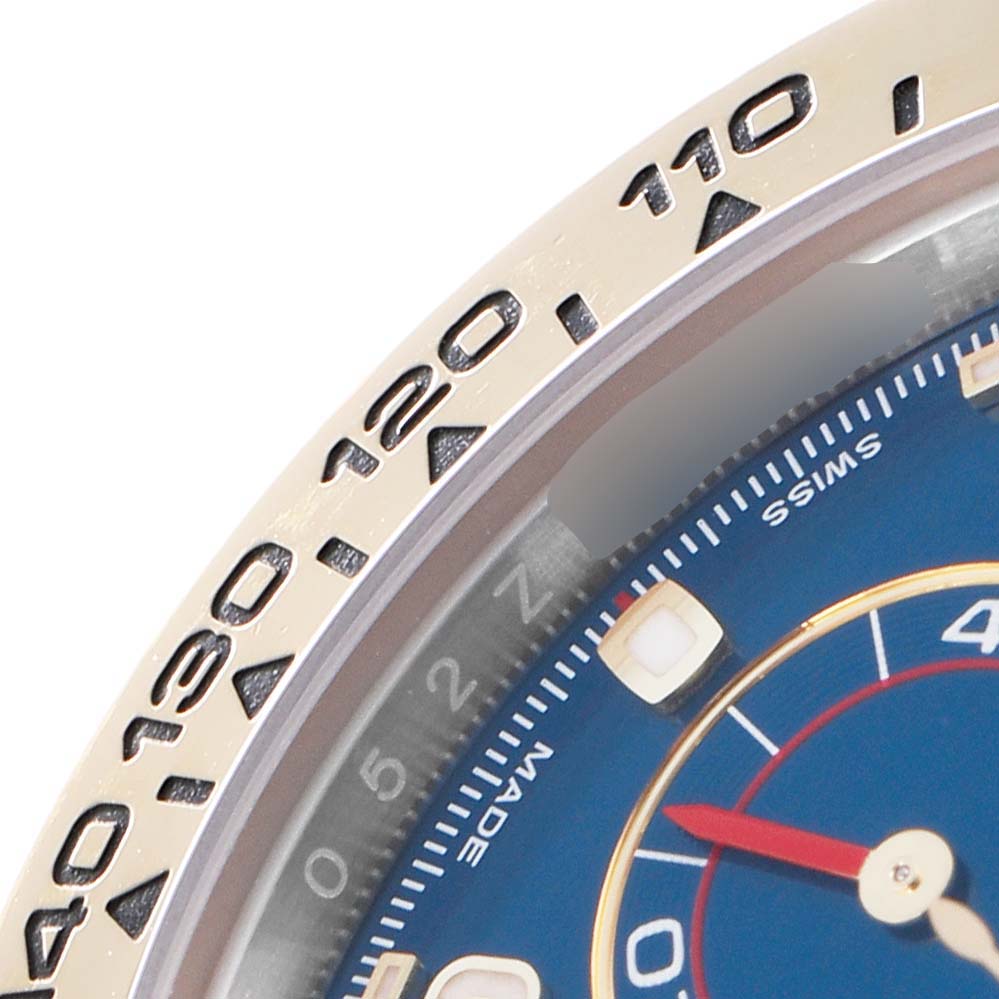 The image shows a close-up of the bezel and partial dial of a Rolex Daytona 116503 Men
s Steel and Gold (two tone) Blue Dial 116503 Men
s Steel and Gold (two tone) Blue Dial watch.