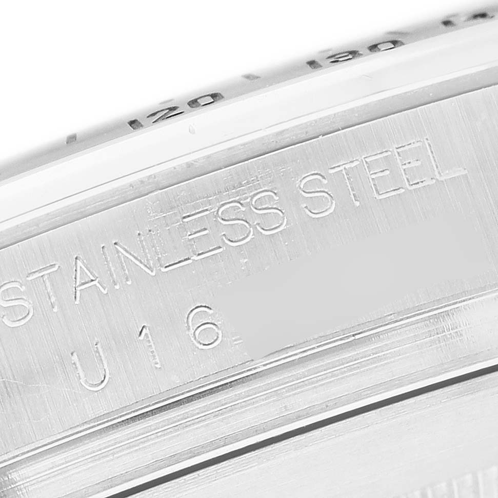 The image shows a close-up of the side of a Rolex Daytona 16520 Men's Stainless Steel White Dial model, focusing on its stainless steel marking.
