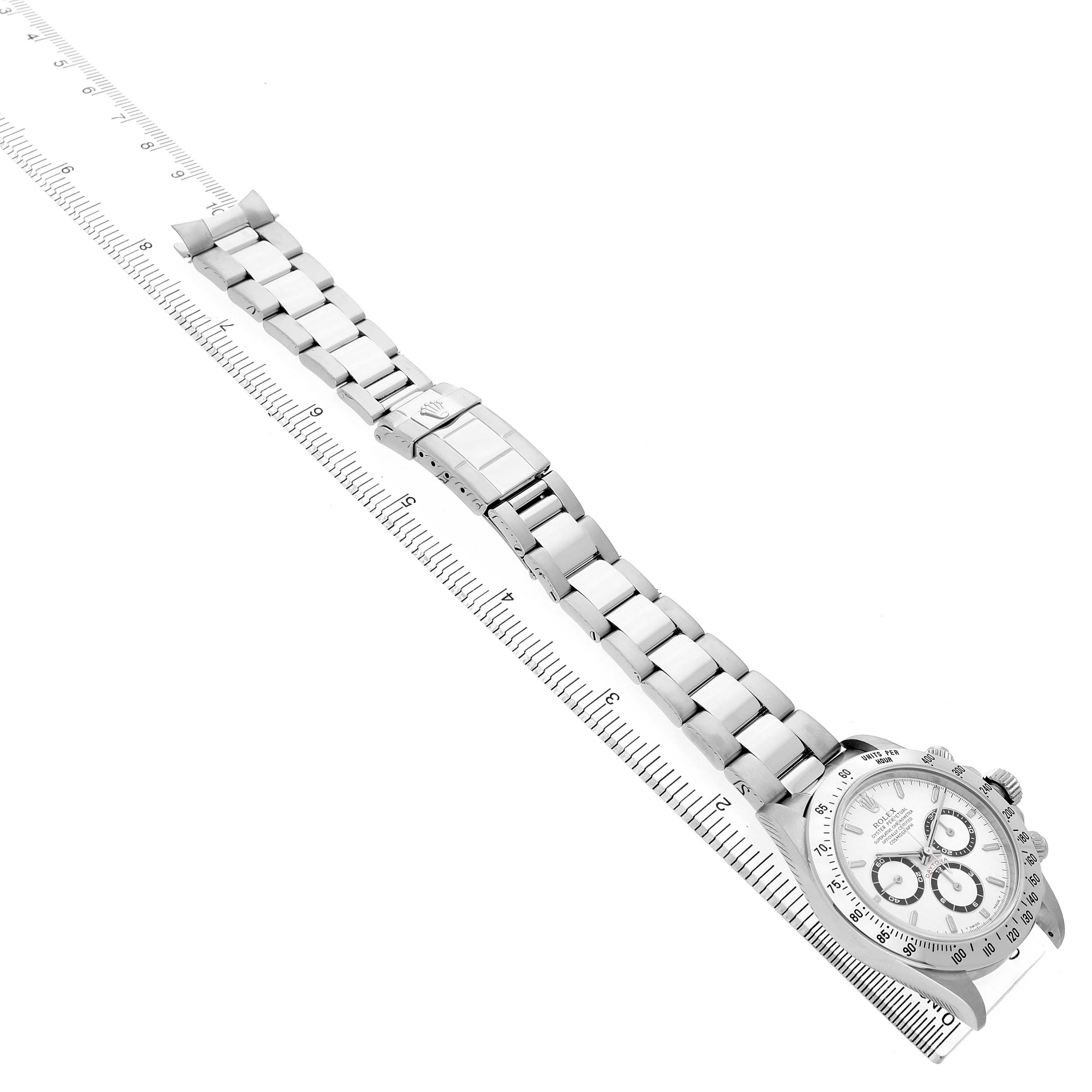 The Rolex Daytona 16520 Men's Stainless Steel White Dial watch is shown from an aerial view with a clear view of its bracelet and clasp, as well as the face.