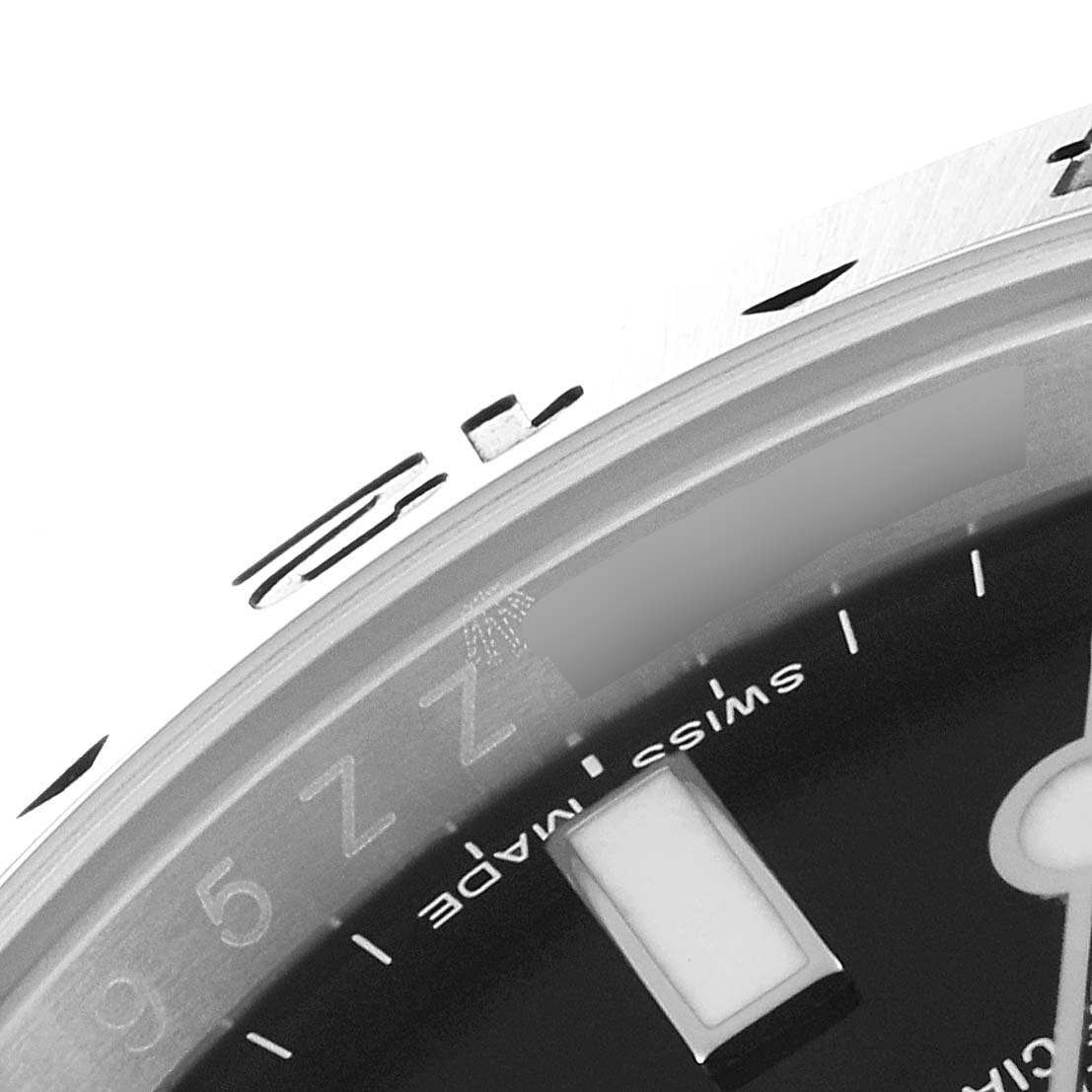 This image shows a close-up of the 3 o'clock marker and part of the bezel of a Rolex Explorer 216570 Men's Stainless Steel Black Dial 216570 Men's Stainless Steel Black Dial watch.