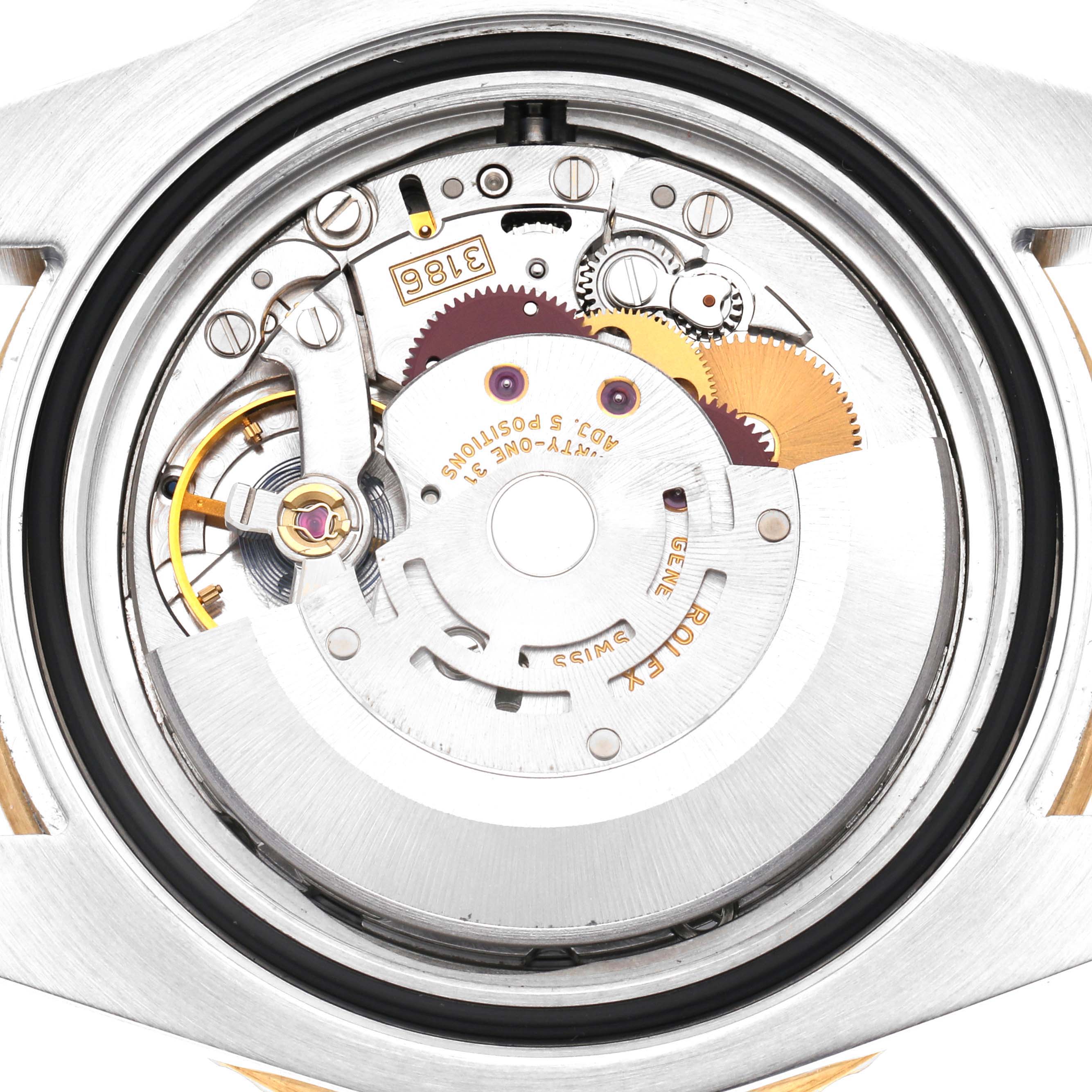 The image shows the movement of a Rolex GMT-Master 116713 Men
s Steel and Gold (two tone) Black Dial 116713 Men
s Steel and Gold (two tone) Black Dial watch from a top-down angle, highlighting gears and mechanical components.