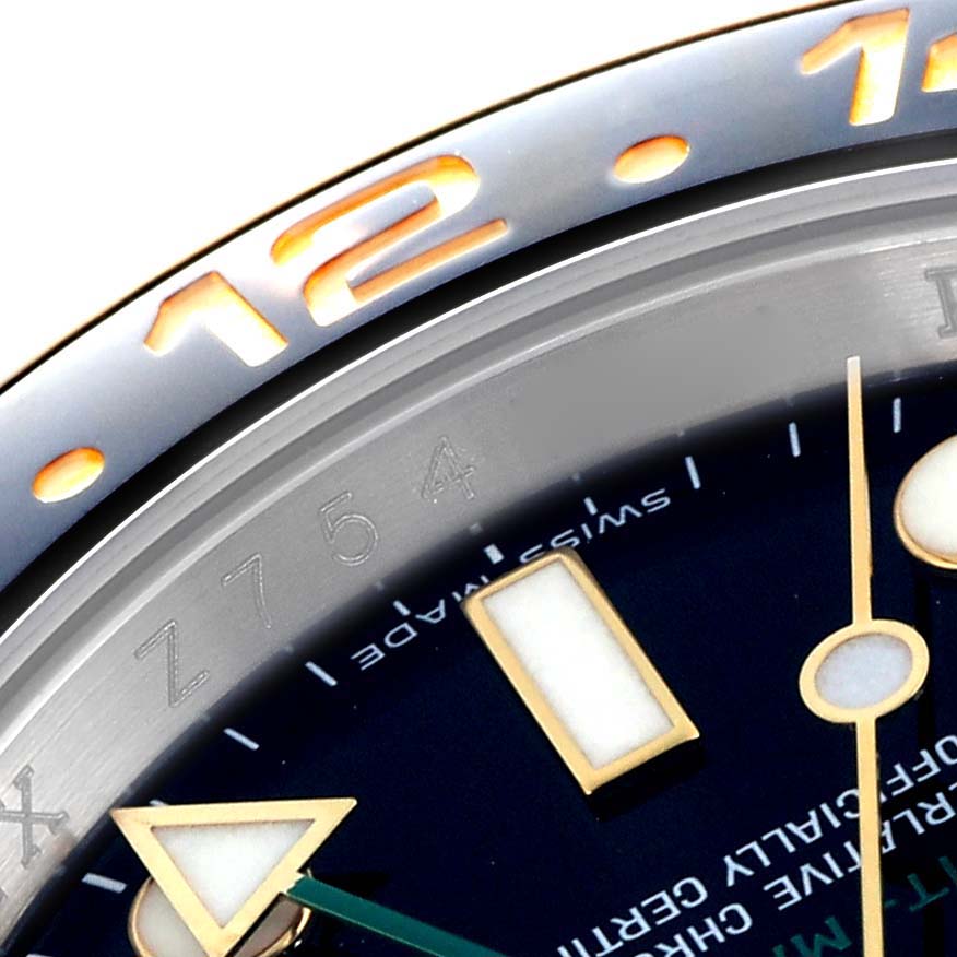 The image shows a close-up of the bezel and part of the dial of a Rolex GMT-Master 116713 Men
s Steel and Gold (two tone) Black Dial 116713 Men
s Steel and Gold (two tone) Black Dial, highlighting numerals and hour markers.