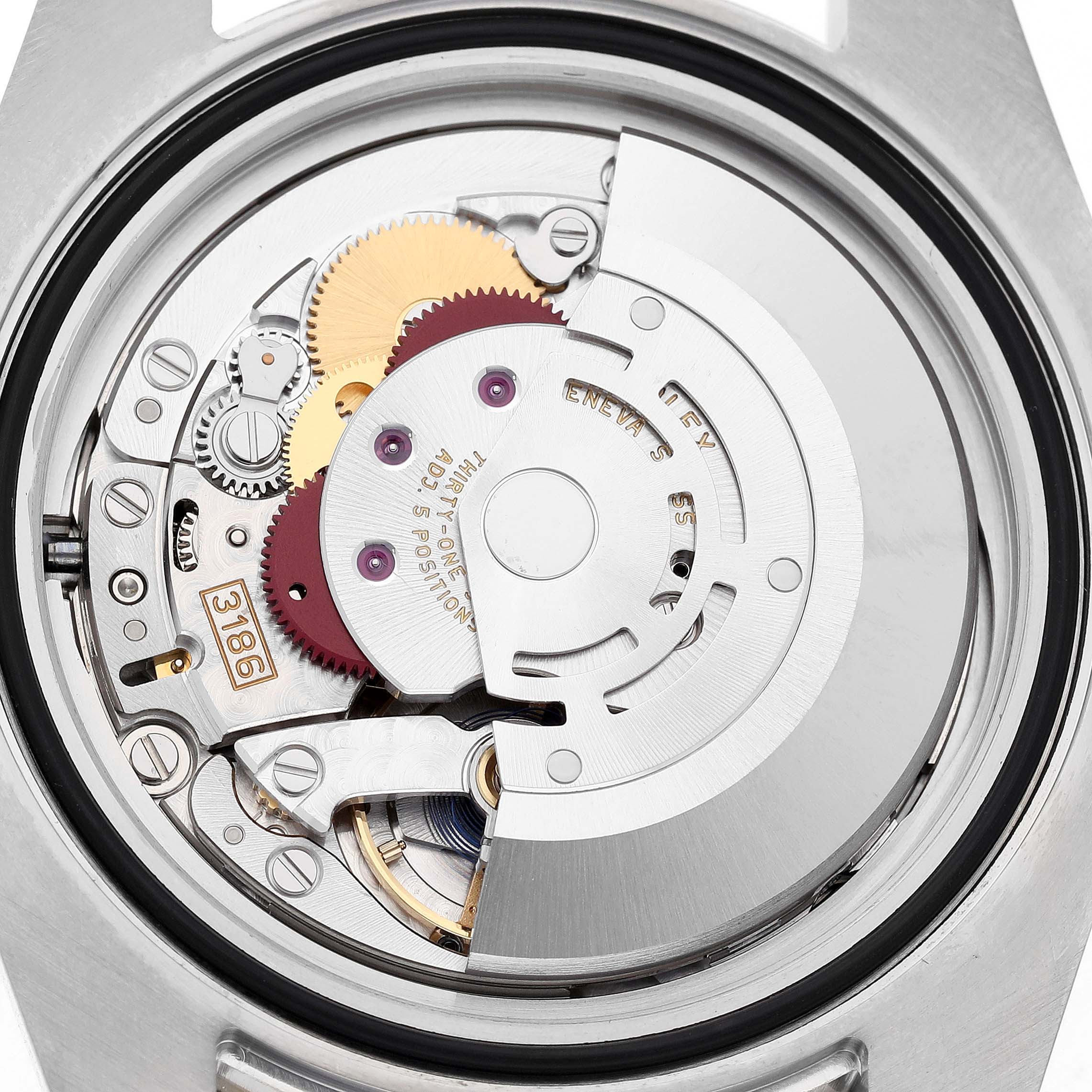 The image shows the movement mechanism of a Rolex GMT-Master M116713LN Men's Stainless Steel Black Dial watch from a rear view, highlighting gears and the rotor.