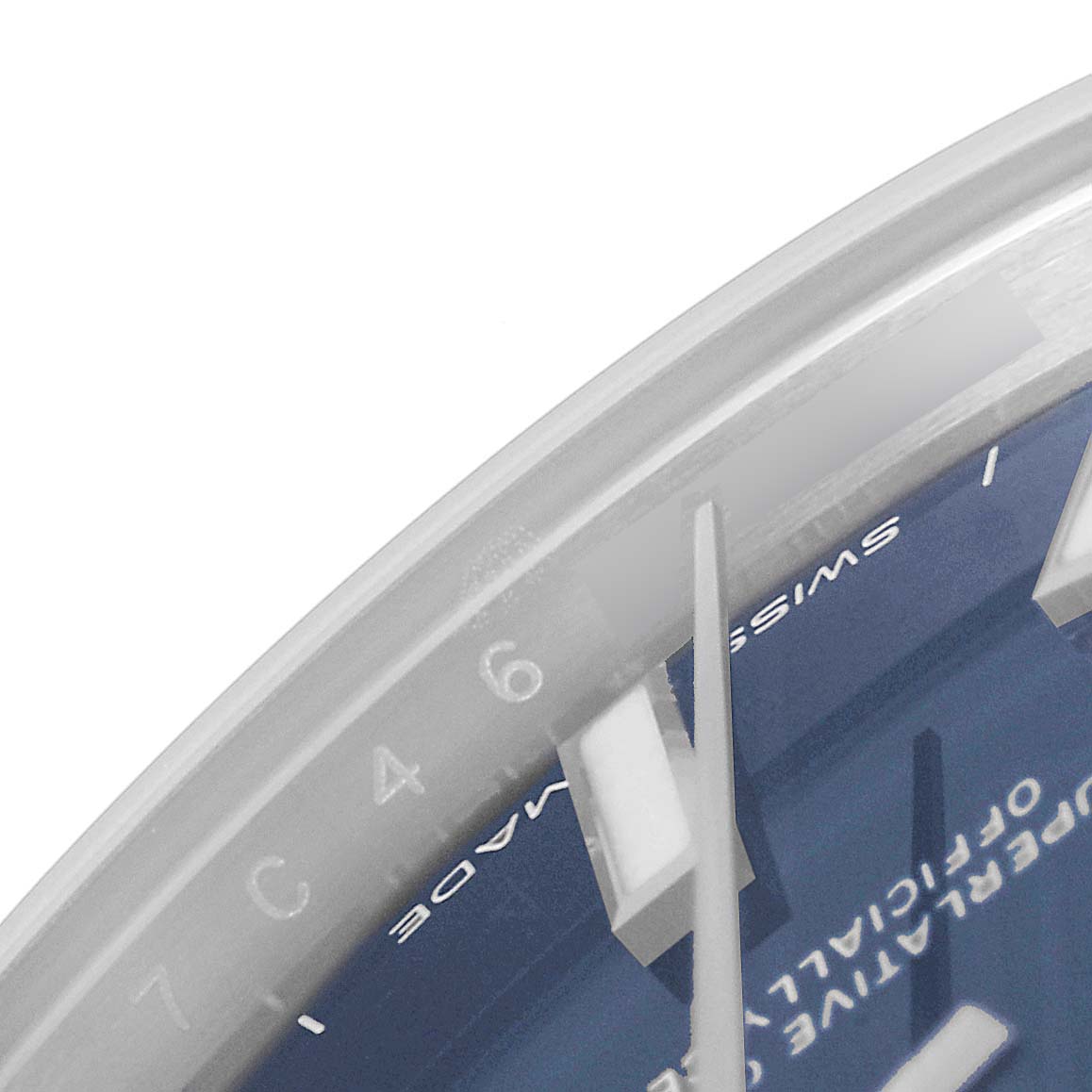 This image shows a close-up of the dial and hands of a Mid-Size Rolex watch from an oblique angle.