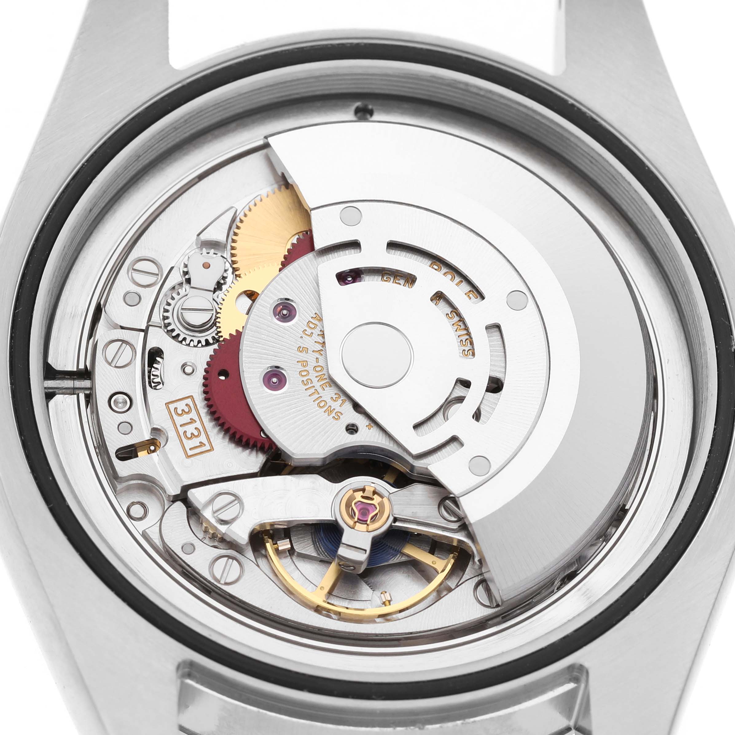 The image shows a close-up of the movement mechanism of a Rolex Milgauss M116400GV Men's Stainless Steel Blue Dial watch from the back, highlighting gears and the rotor.