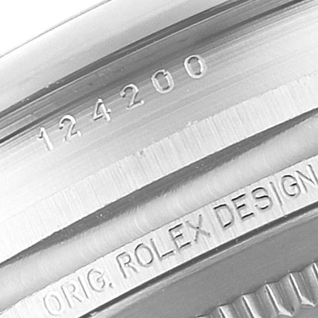 The image shows a close-up of the engraving on the case back of a Rolex Oyster Perpetual 124200 Men
s Stainless Steel Silver Dial 124200 Men
s Stainless Steel Silver Dial model.