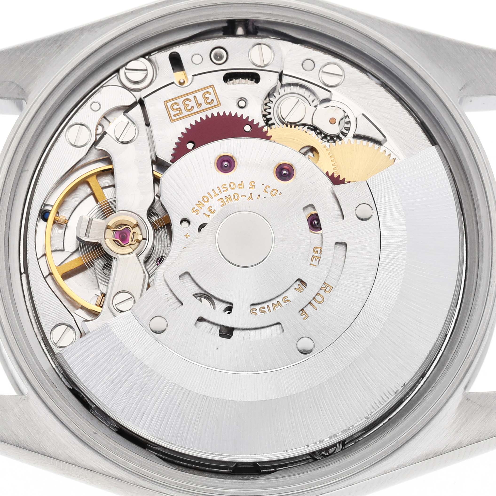 The image shows the Rolex Oyster Perpetual 15200 Men's Stainless Steel Black Dial's movement from a top view, revealing gears, rotor, and intricate mechanical details.