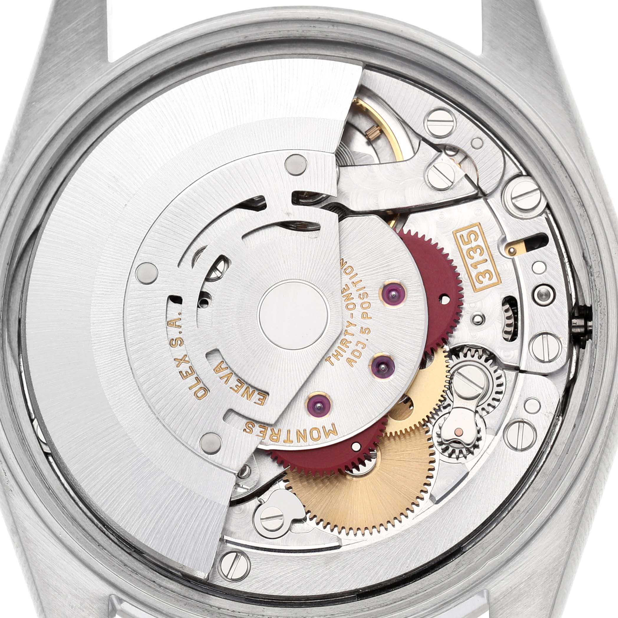 The image shows a close-up view of the Rolex Date 15200 Men's Stainless Steel Black Dial model's movement, revealing gears and the rotor inside.