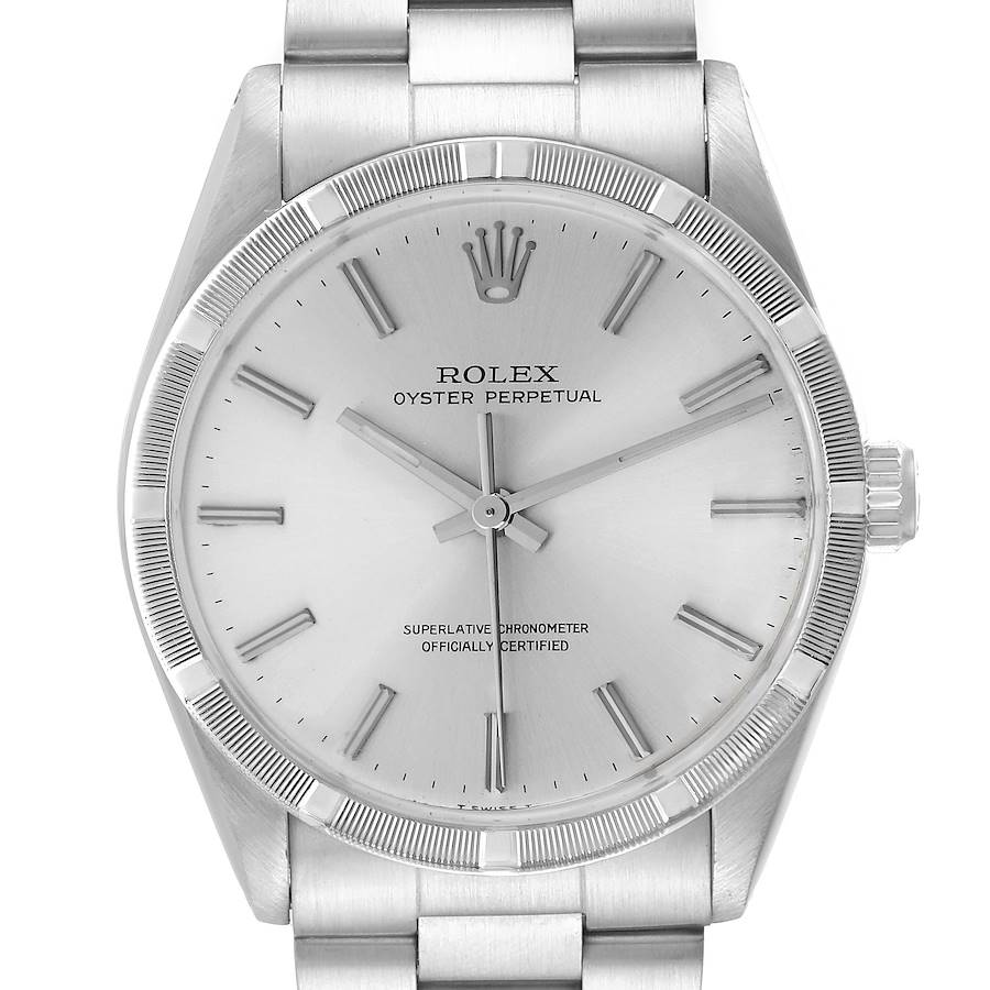 The Rolex Oyster Perpetual watch is shown from a front angle, highlighting the dial, bezel, and part of the bracelet.