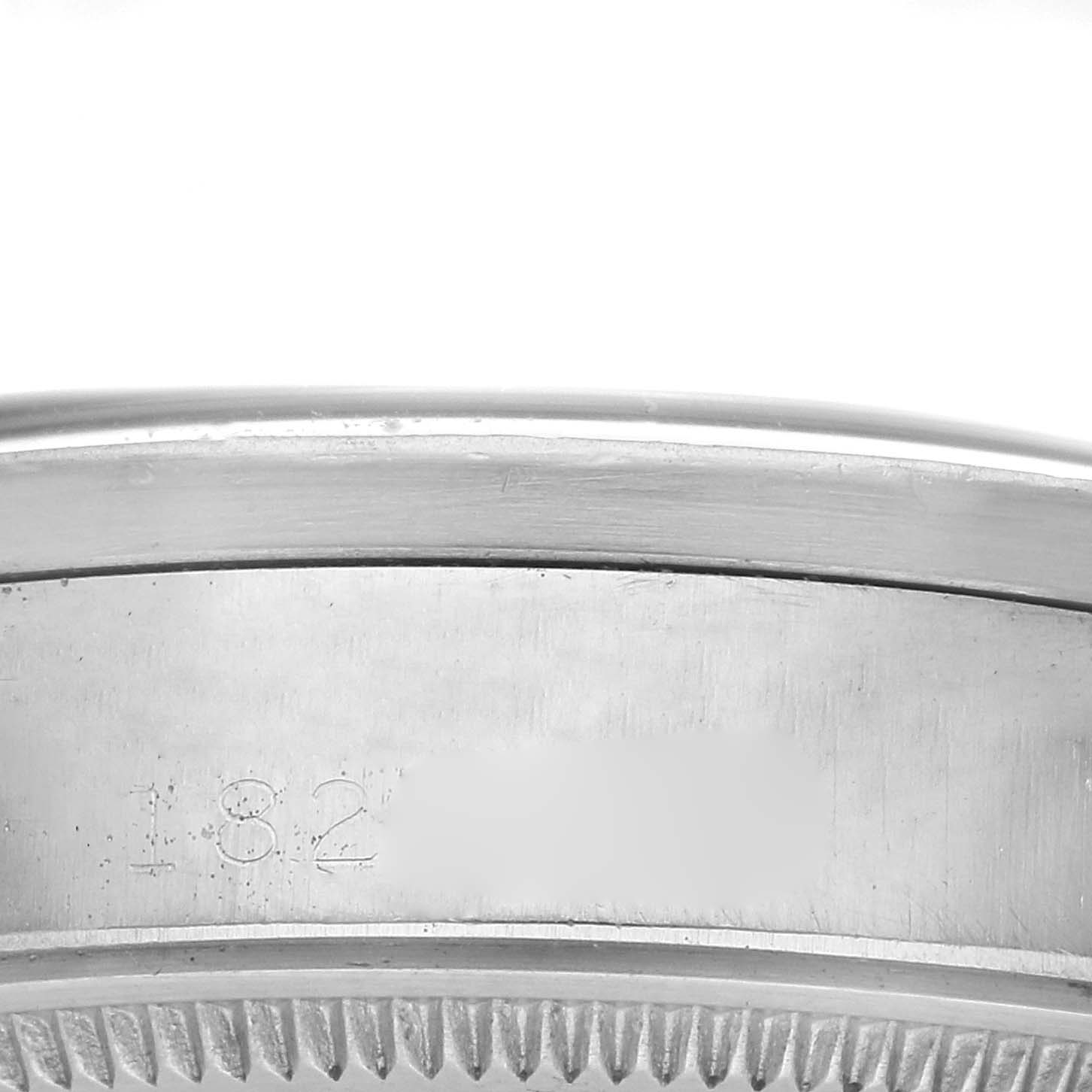 The image shows a close-up of the side of the bezel and case with engravings on the Rolex Oyster Perpetual 1007 Men
s Stainless Steel Silver Dial 1007 Men
s Stainless Steel Silver Dial watch.