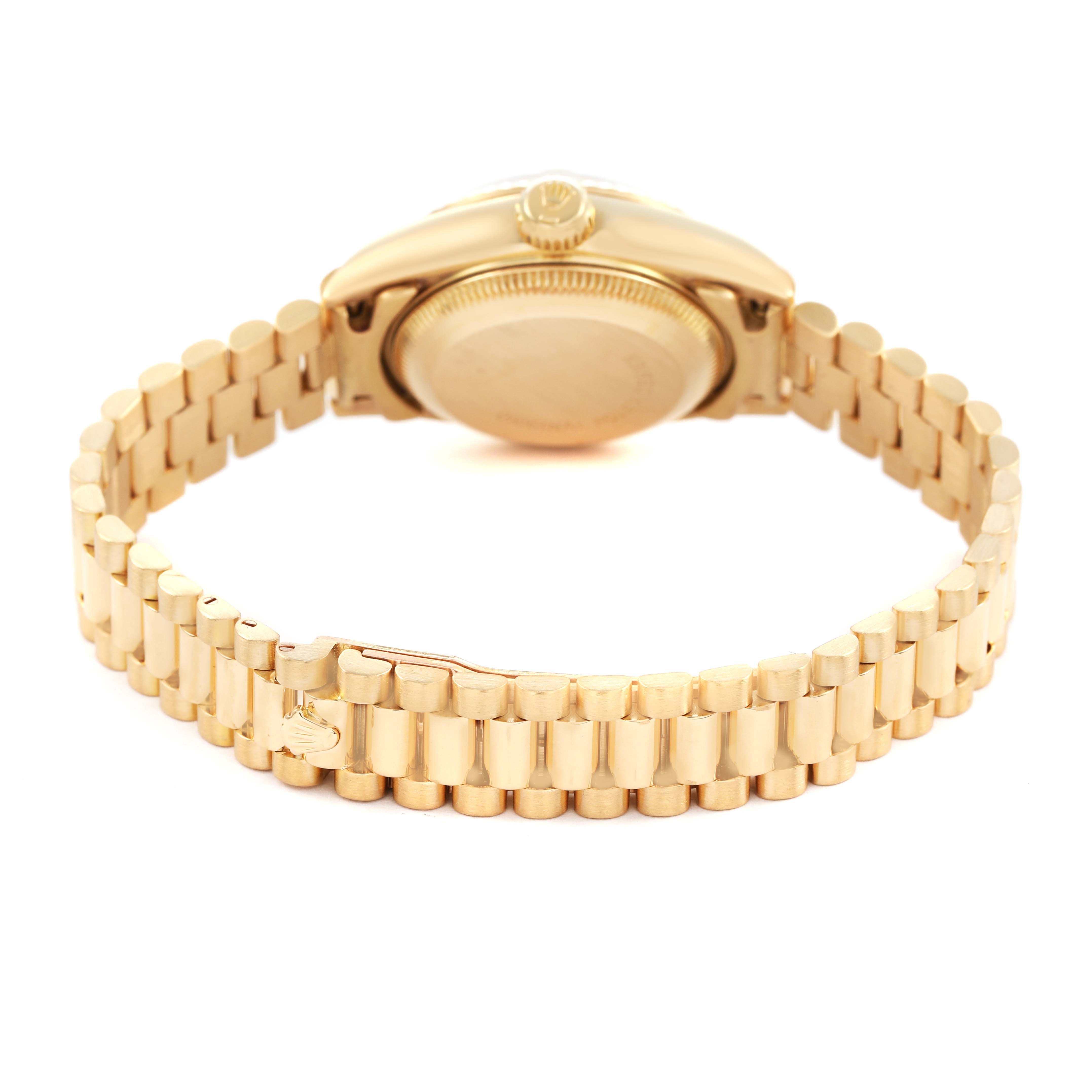 The Rolex President 69178 Women's Yellow Gold Champagne Dial model watch is shown from the back, featuring the case back, bracelet, and clasp.