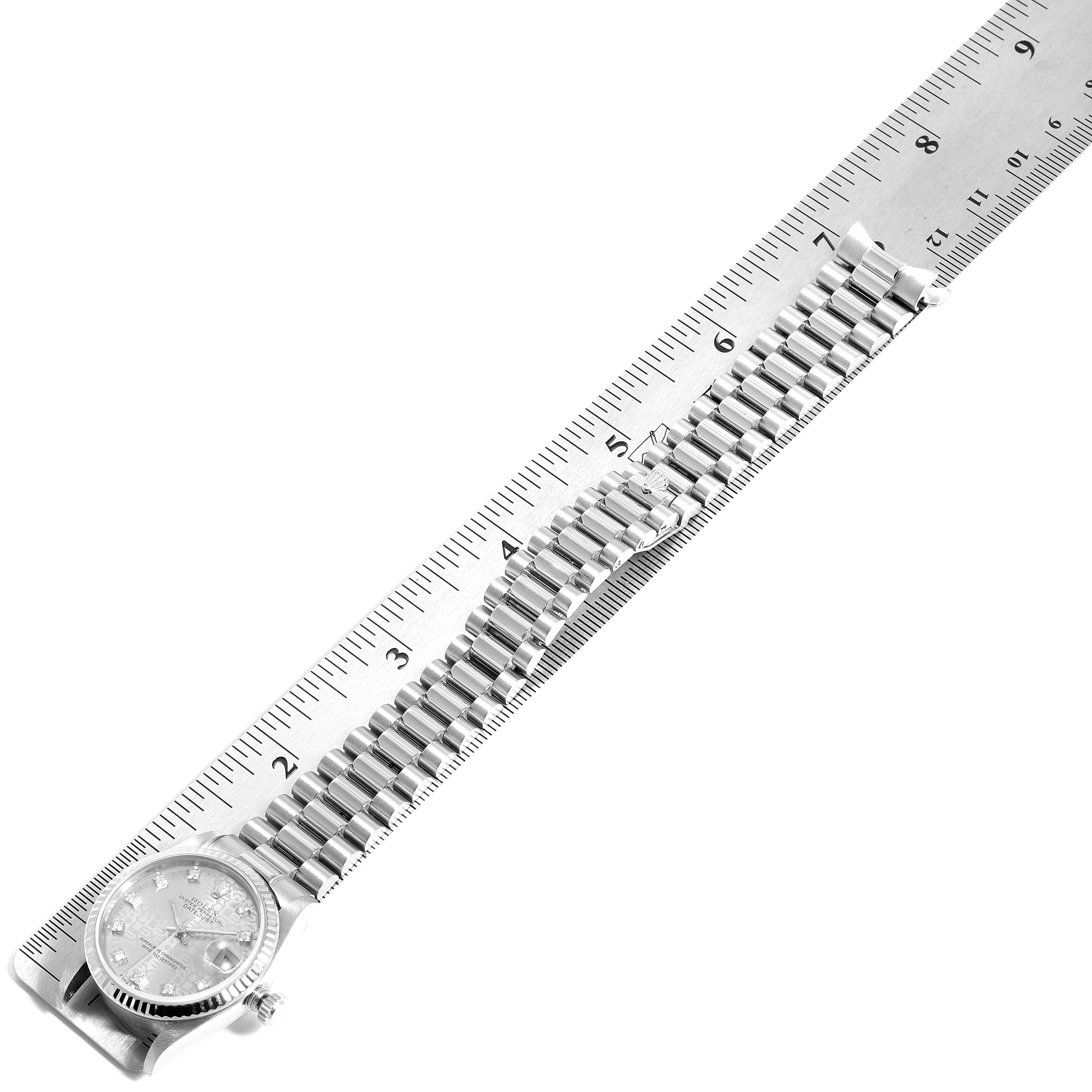 The image shows a Rolex President 68279 Women's White Gold Silver Dial 68279 Women's White Gold Silver Dial model watch laid flat against a ruler, displaying the face and full metal bracelet.