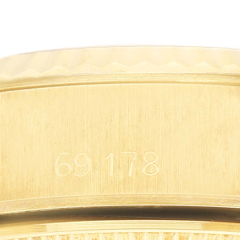This image shows a close-up of the side of a Rolex President 69178 Women's Yellow Gold Champagne Dial watch, focusing on its engraved model number.