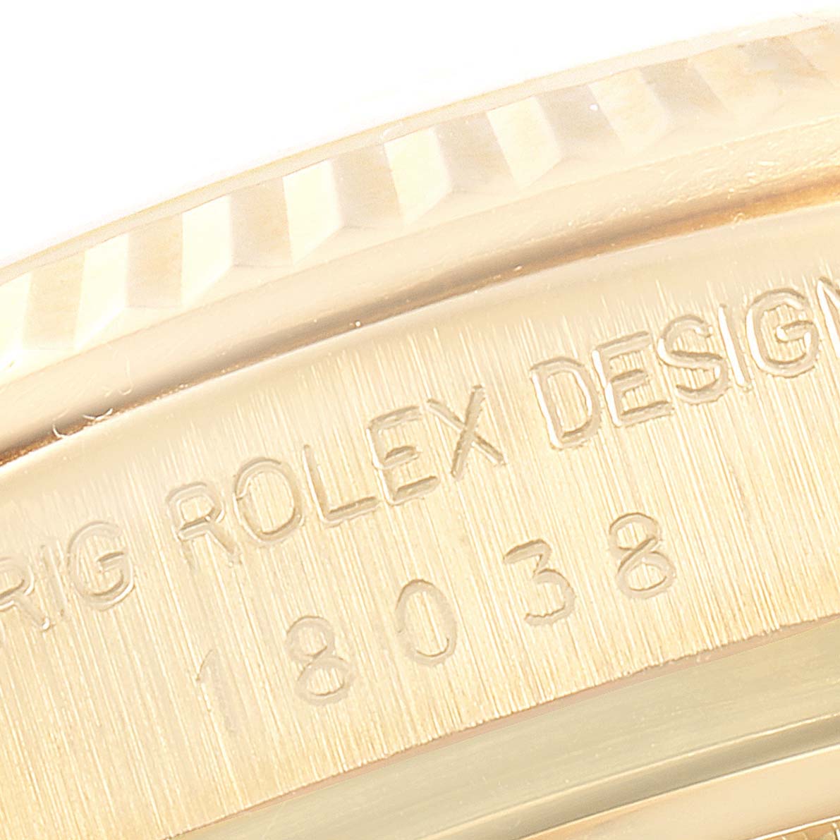 The image shows the side view of a Rolex President 18038 Men's Yellow Gold Champagne Dial 18038 Men's Yellow Gold Champagne Dial model's case with visible engravings "ORIG ROLEX DESIGN" and "18038".