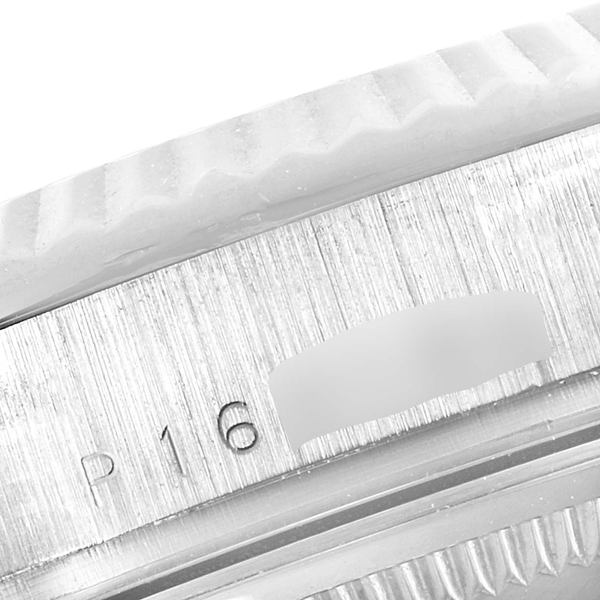 This close-up image shows the engraved details on the side of a Rolex President 118239 Men's White Gold Brown Dial 118239 Men's White Gold Brown Dial model watch case.