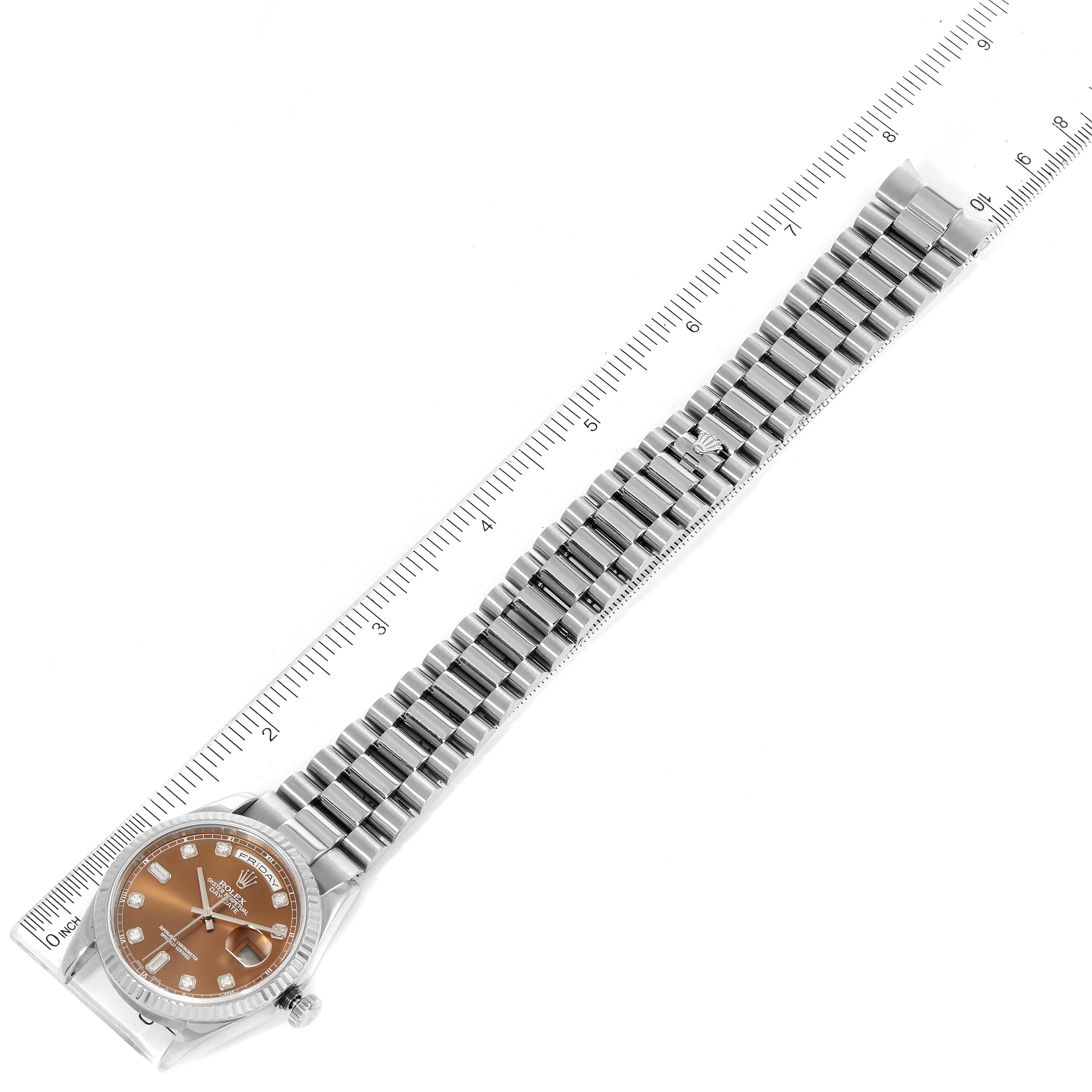 The image shows the Rolex President 118239 Men's White Gold Brown Dial 118239 Men's White Gold Brown Dial model watch face and metal band, laid next to a measuring ruler.