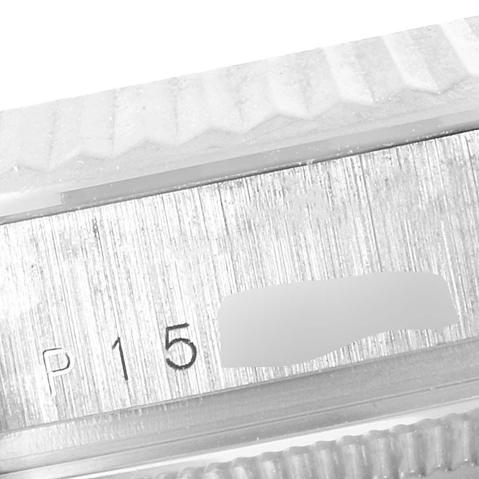 This close-up image shows the serial number area and the fluted bezel of a Rolex President 118239 Men's White Gold Silver Dial 118239 Men's White Gold Silver Dial model watch.