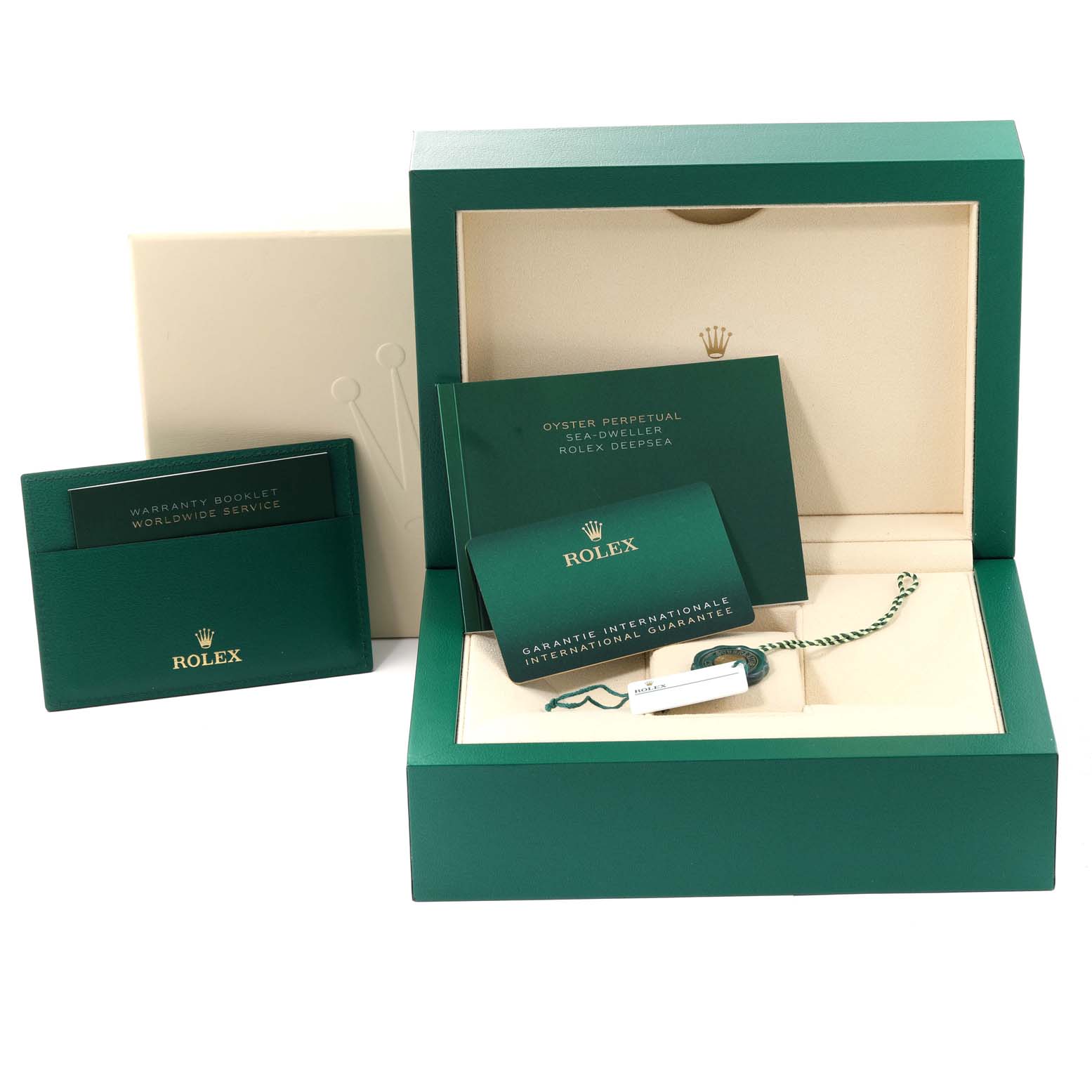 The image shows the open box and accompanying booklets of a Rolex Sea-Dweller 126660 Men
s Stainless Steel Black Dial 126660 Men
s Stainless Steel Black Dial, along with warranty cards and tags.