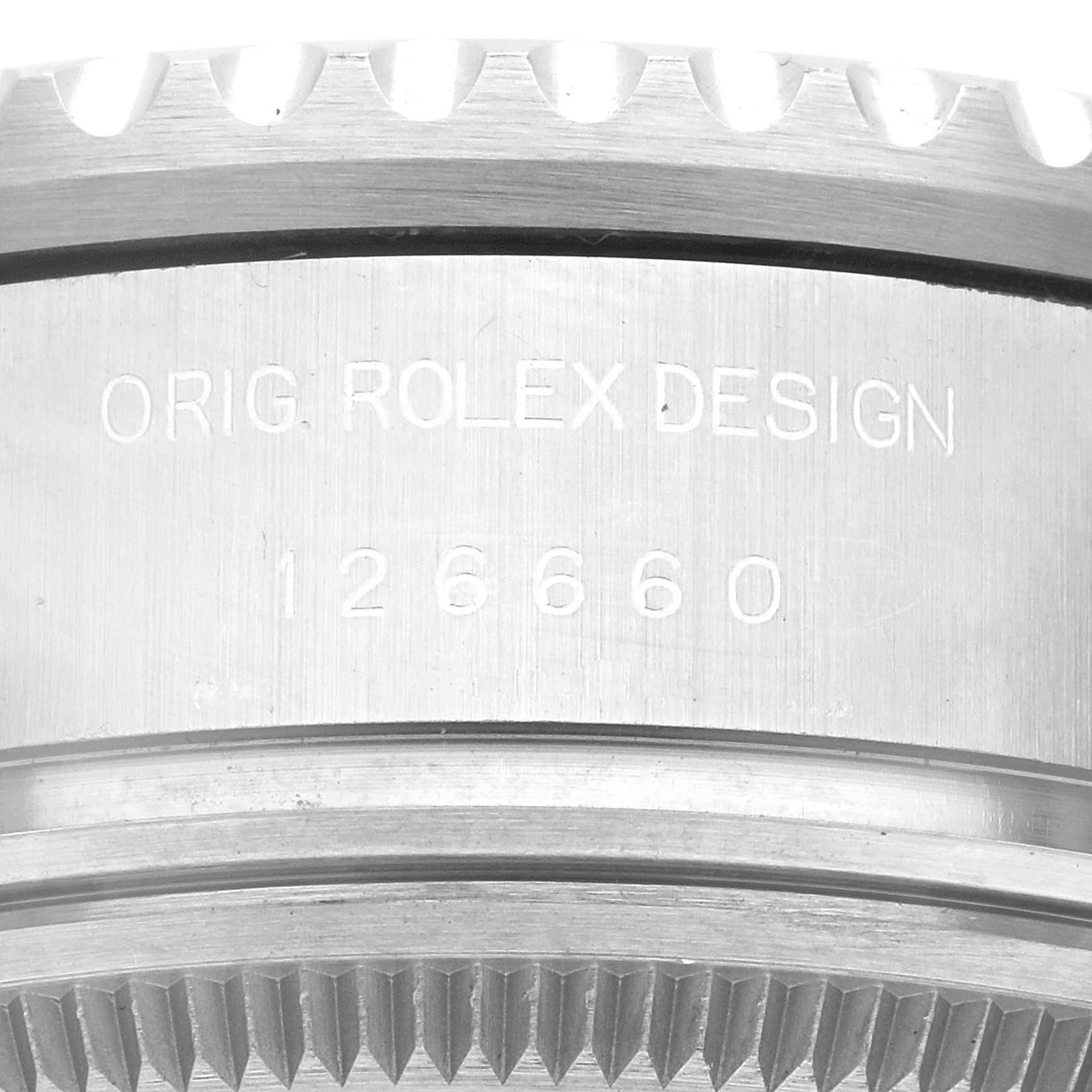 This close-up angle shows the engraved model number and design engraving of the Rolex Sea-Dweller 126660 Men
s Stainless Steel Black Dial 126660 Men
s Stainless Steel Black Dial watch bezel.