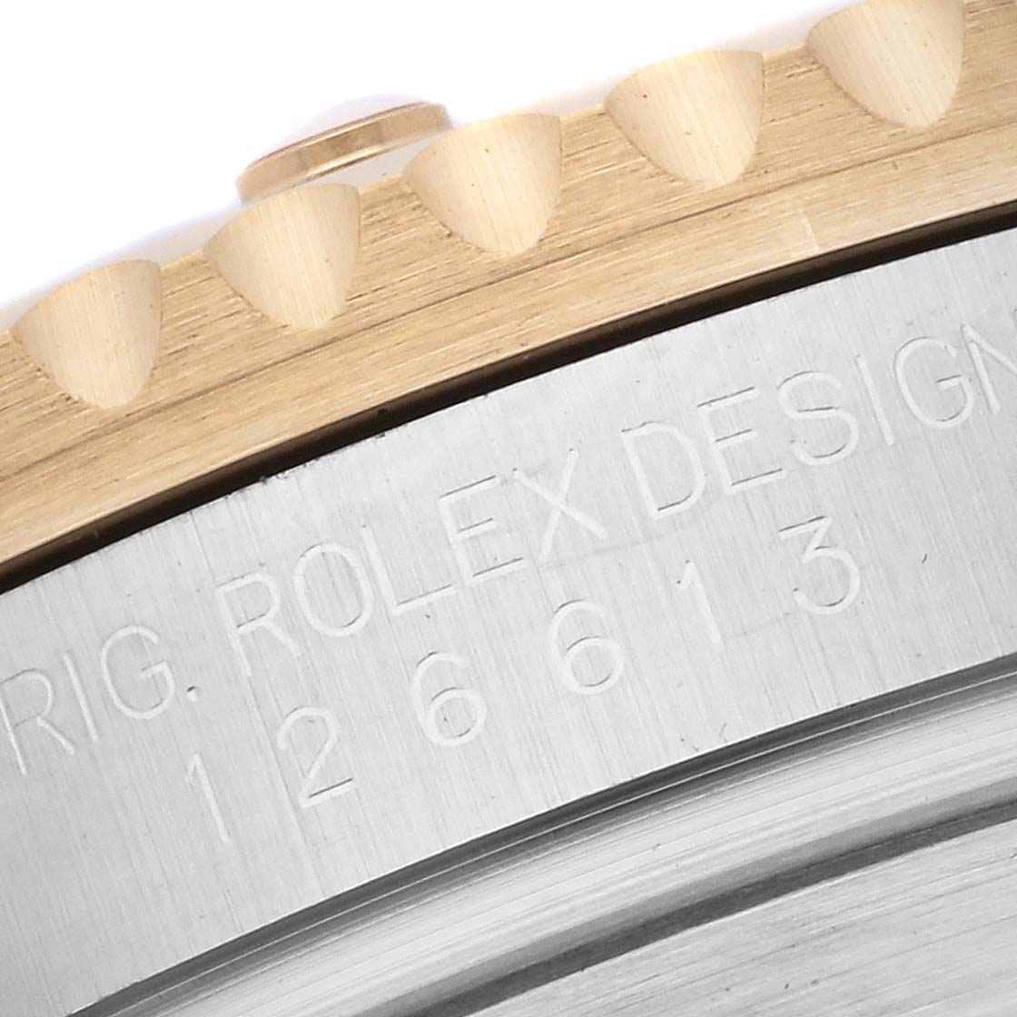 This image shows a close-up of the bezel and case side of a Rolex Submariner 126613 Men's Steel and Gold (two tone) Blue Dial 126613 Men's Steel and Gold (two tone) Blue Dial, with part of the engraved model number visible.