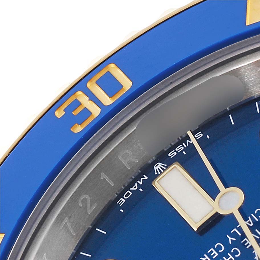 Close-up of a Rolex Submariner 126613LB Men's Steel and Gold (two tone) Blue Dial 126613LB Men's Steel and Gold (two tone) Blue Dial showing the blue bezel with the "30" marking and parts of the dial and hands.