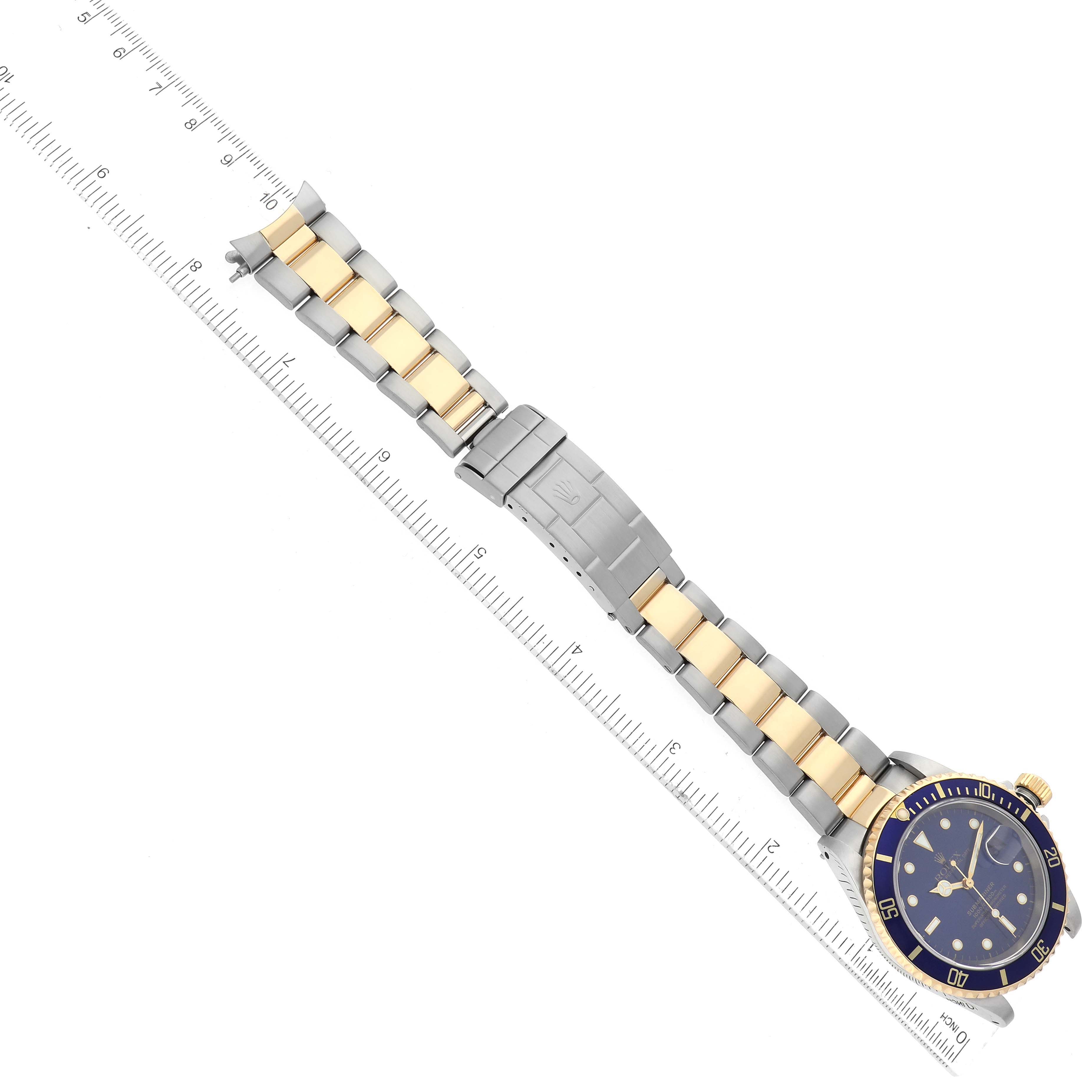 This image shows a top-down view of a Rolex Submariner 16613 Men's Steel and Gold (two tone) Blue Dial 16613 Men's Steel and Gold (two tone) Blue Dial, highlighting the two-tone bracelet, bezel, face, and clasp.