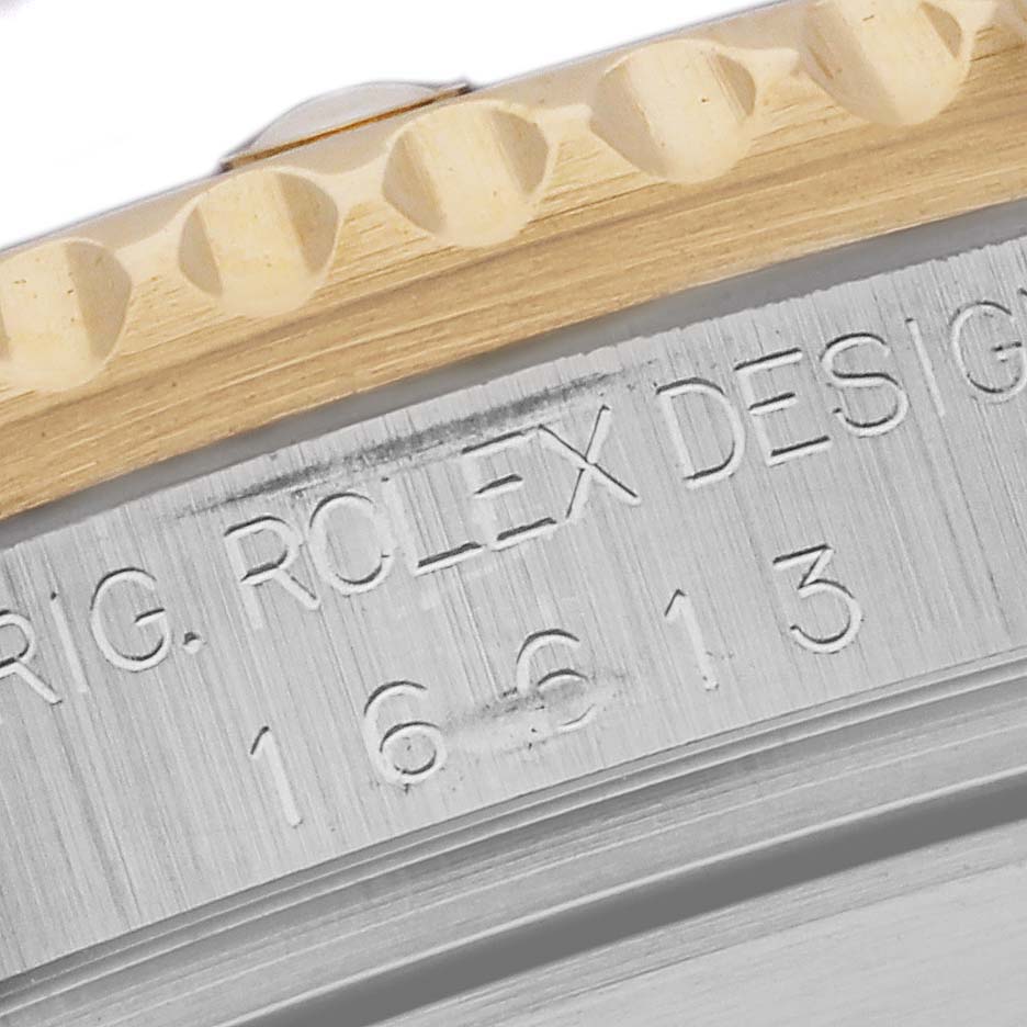 The image shows a close-up of the side of a Rolex Submariner 16613 Men's Steel and Gold (two tone) Blue Dial 16613 Men's Steel and Gold (two tone) Blue Dial, focusing on the engraved model number and part of the bezel.