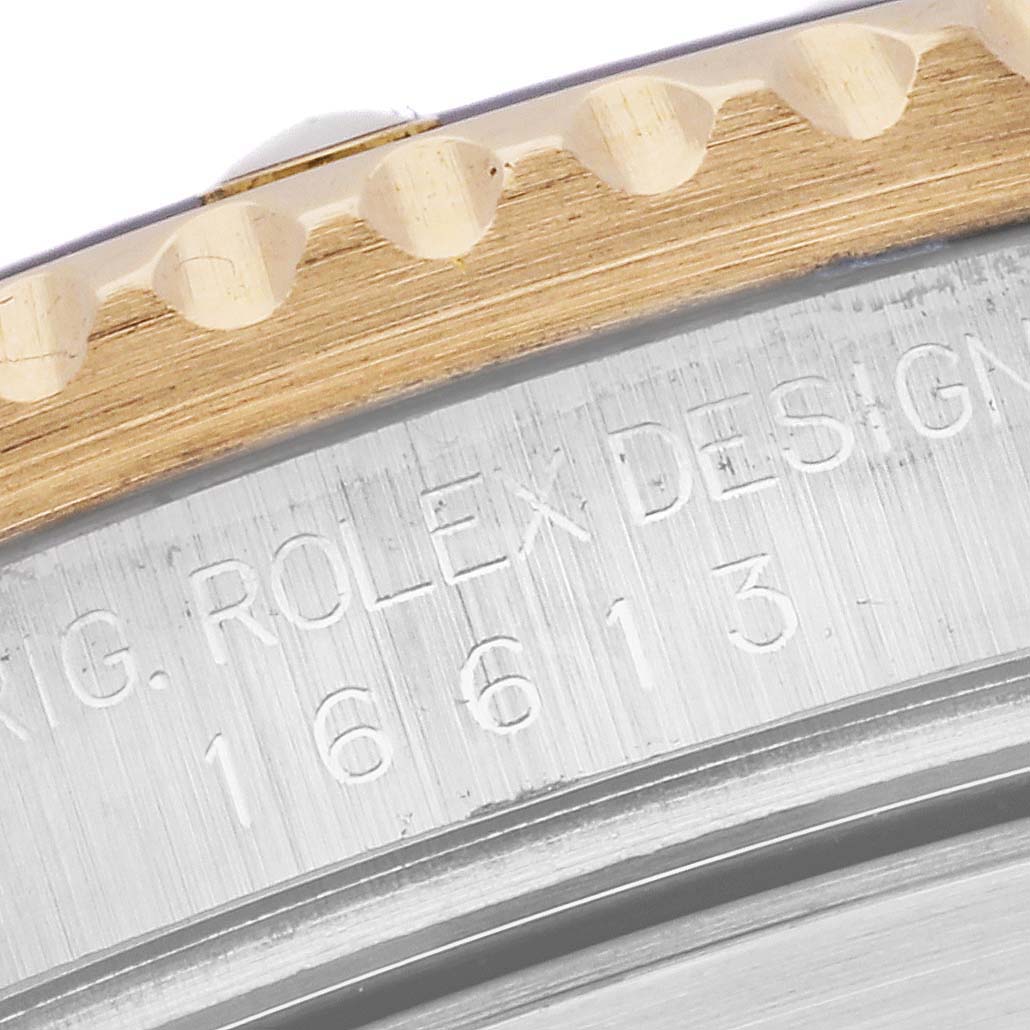This close-up shows the bezel and case of a Rolex Submariner 16613 Men's Steel and Gold (two tone) Blue Dial 16613 Men's Steel and Gold (two tone) Blue Dial watch, displaying the model number and brand engraving.