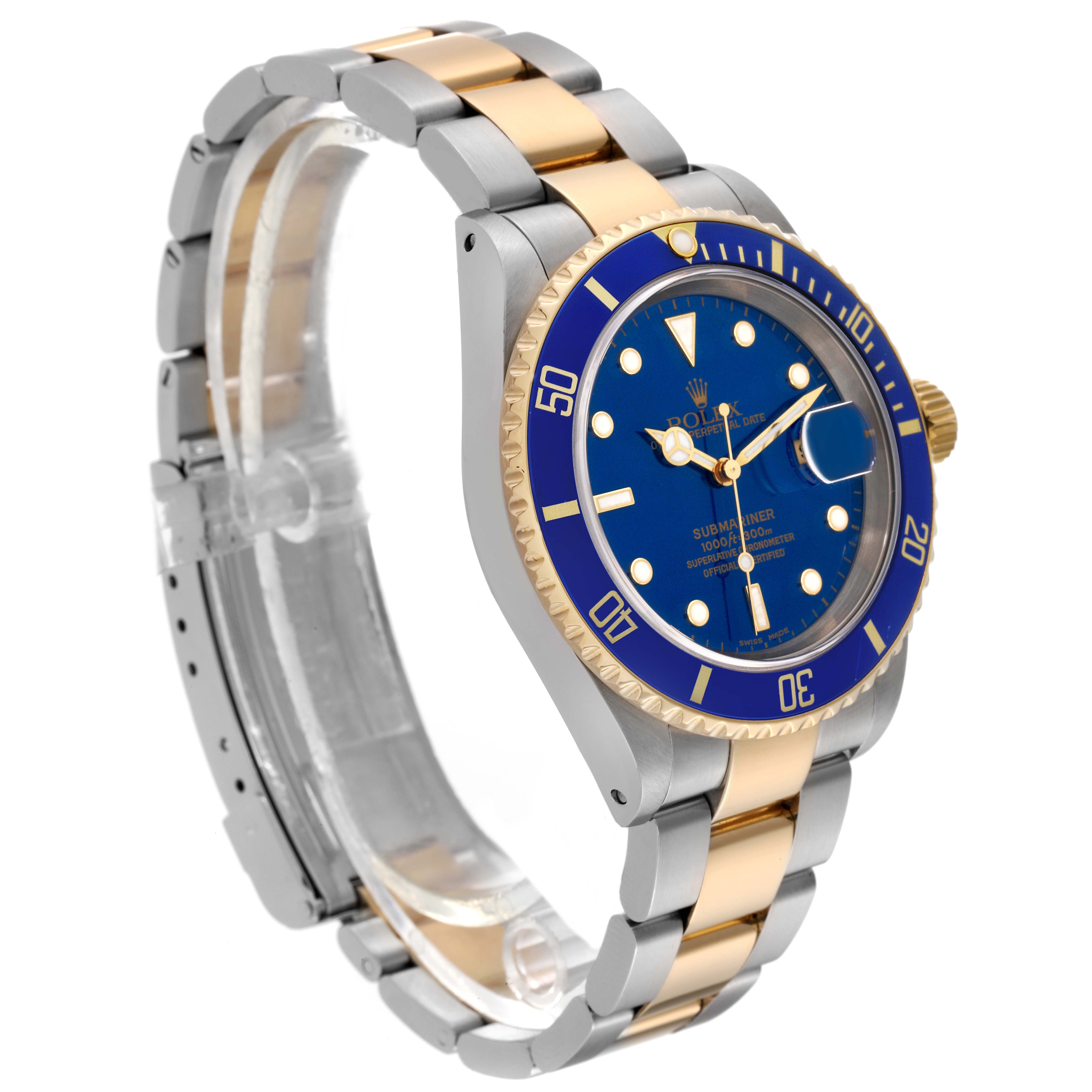 The Rolex Submariner 16613 Men's Steel and Gold (two tone) Blue Dial 16613 Men's Steel and Gold (two tone) Blue Dial watch is shown at an angle showcasing the face, bezel, bracelet, and part of the clasp.