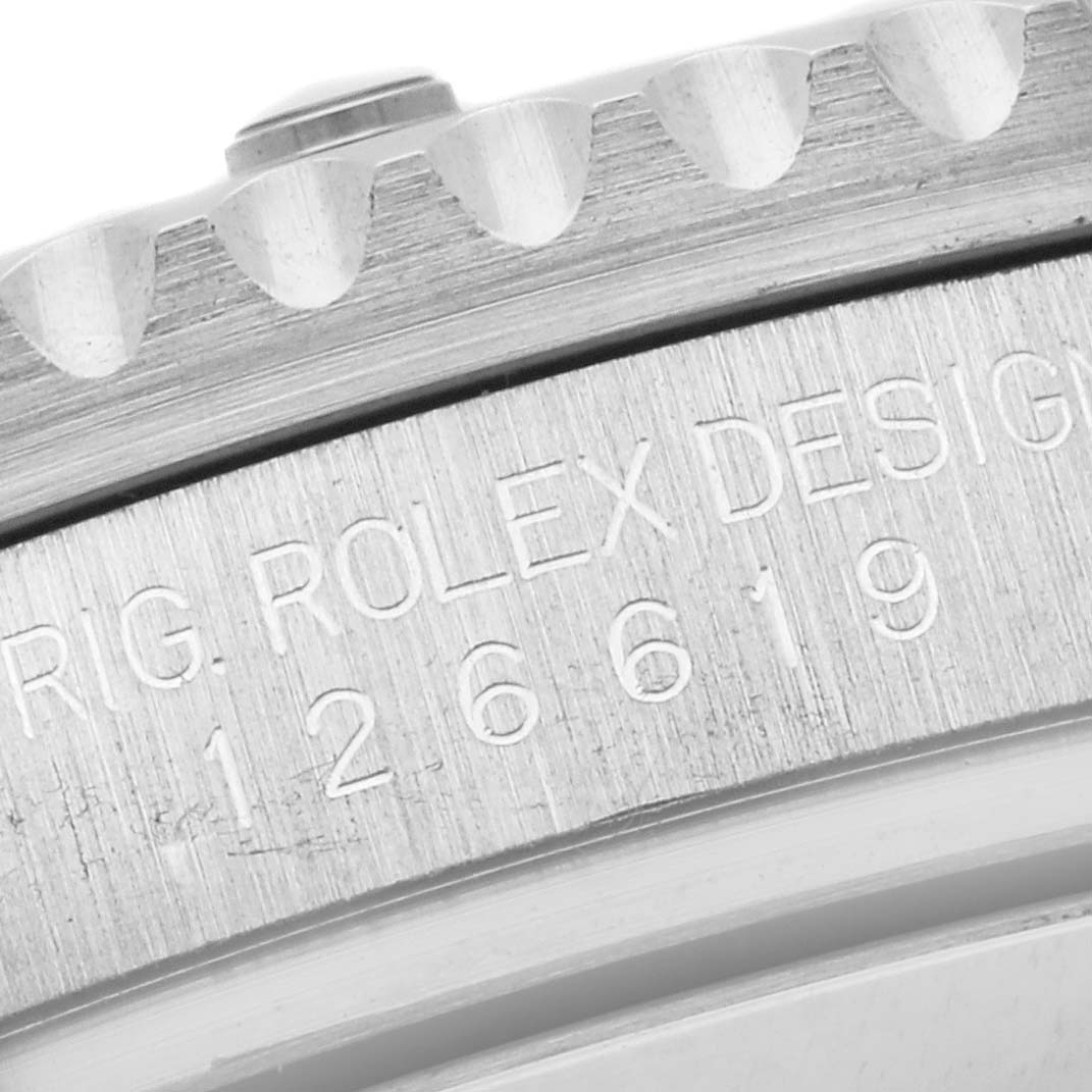 Close-up of the Rolex Submariner 126619 Men's White Gold Black Dial 126619 Men's White Gold Black Dial's case side, showing the engraved design model number and part of the bezel.
