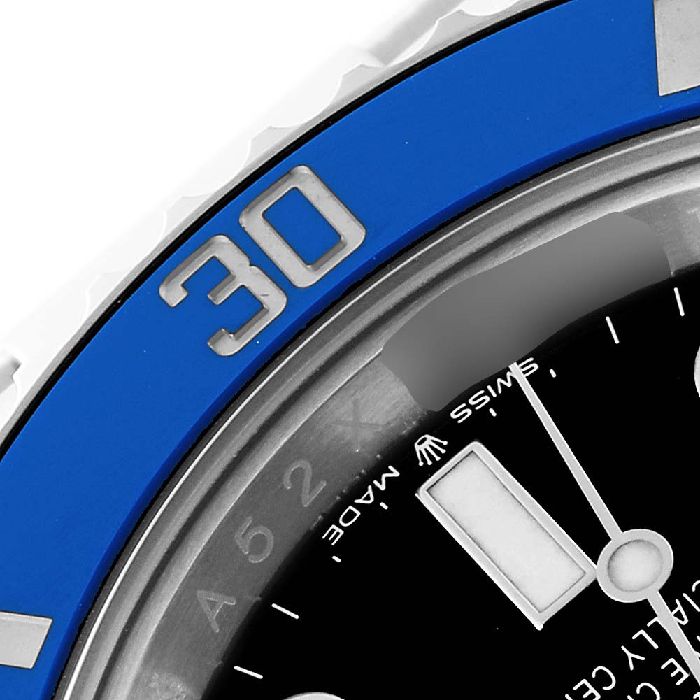 A close-up of the Rolex Submariner 126619 Men's White Gold Black Dial 126619 Men's White Gold Black Dial shows the bezel, chapter ring, and dial with the "30" marker on the blue bezel.