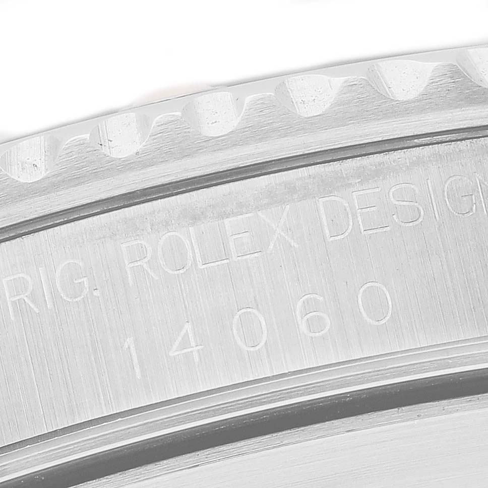 The image shows a close-up of the Rolex Submariner 14060M Men's Stainless Steel Black Dial's model number on its stainless steel caseback edge.