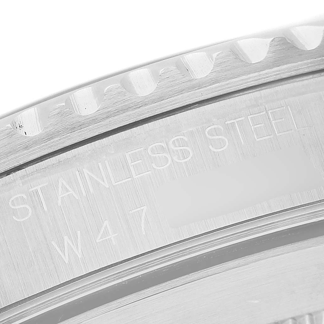 The image shows a close-up of the bezel and case back edge of a Rolex Submariner 14060M Men's Stainless Steel Black Dial, highlighting "STAINLESS STEEL" text.