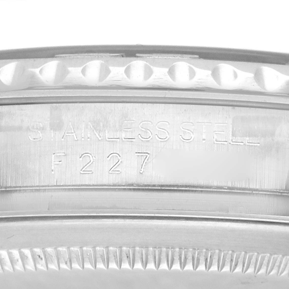 The image shows a close-up of the Rolex Yacht-Master 16622 Men
s Stainless Steel Silver Dial 16622 Men
s Stainless Steel Silver Dial
s stainless steel case side with engraved markings.