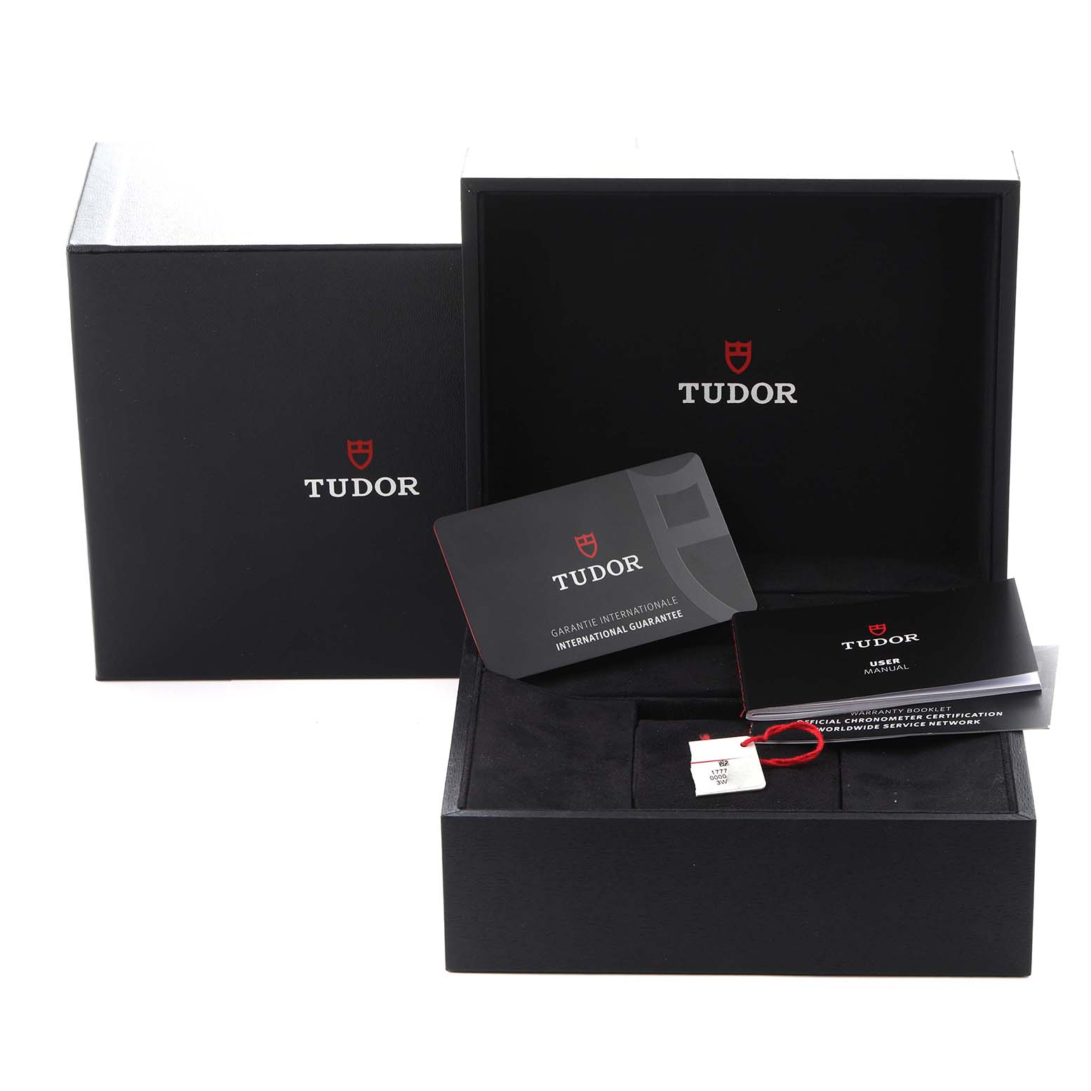 The image shows the Tudor Heritage Black Bay 79030 Men
s Stainless Steel Black Dial 79030 Men
s Stainless Steel Black Dial packaging, including boxes, a warranty card, and a manual, viewed from the front.